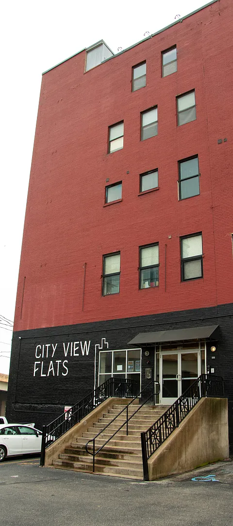 Modern urban living at City View Flats, featuring a striking red brick exterior and convenient central location.