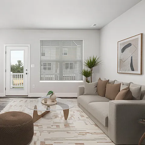 Modern living room with sleek furniture, a large window, and a cozy seating area.
