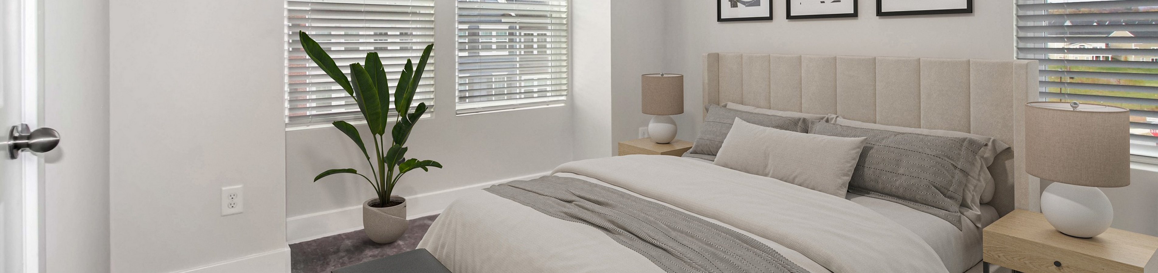 Bedroom showing a queen bed between two sets of windows on the corner at The Terrace at Sycamore Ridge Rental Townhomes