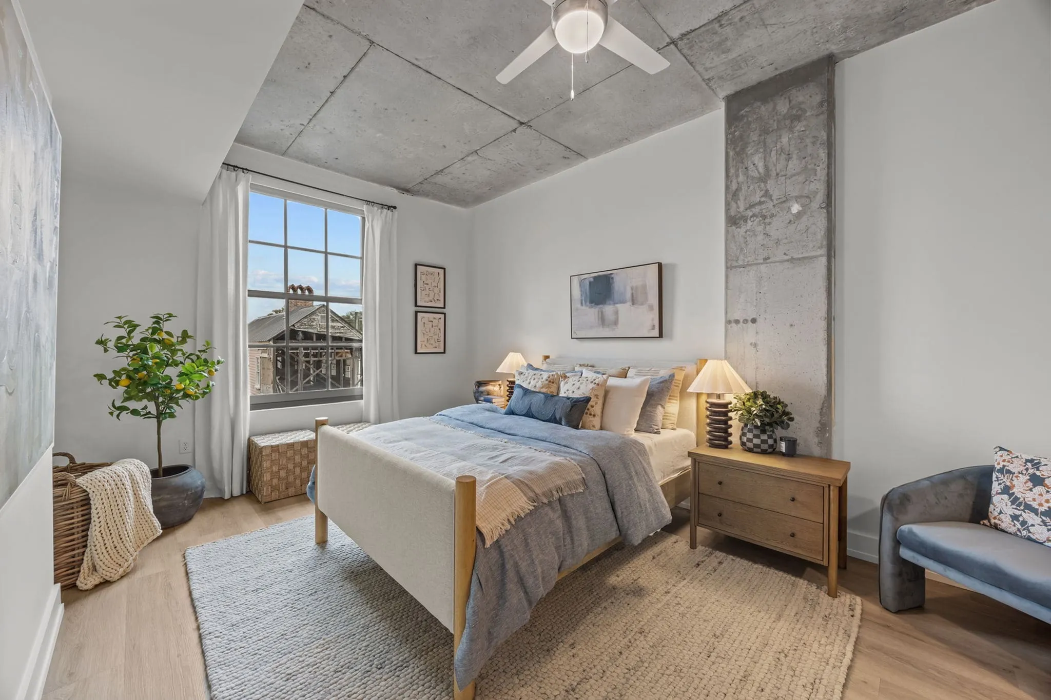 Inviting bedroom with a plush bed, stylish decor, and a large window offering abundant natural light.