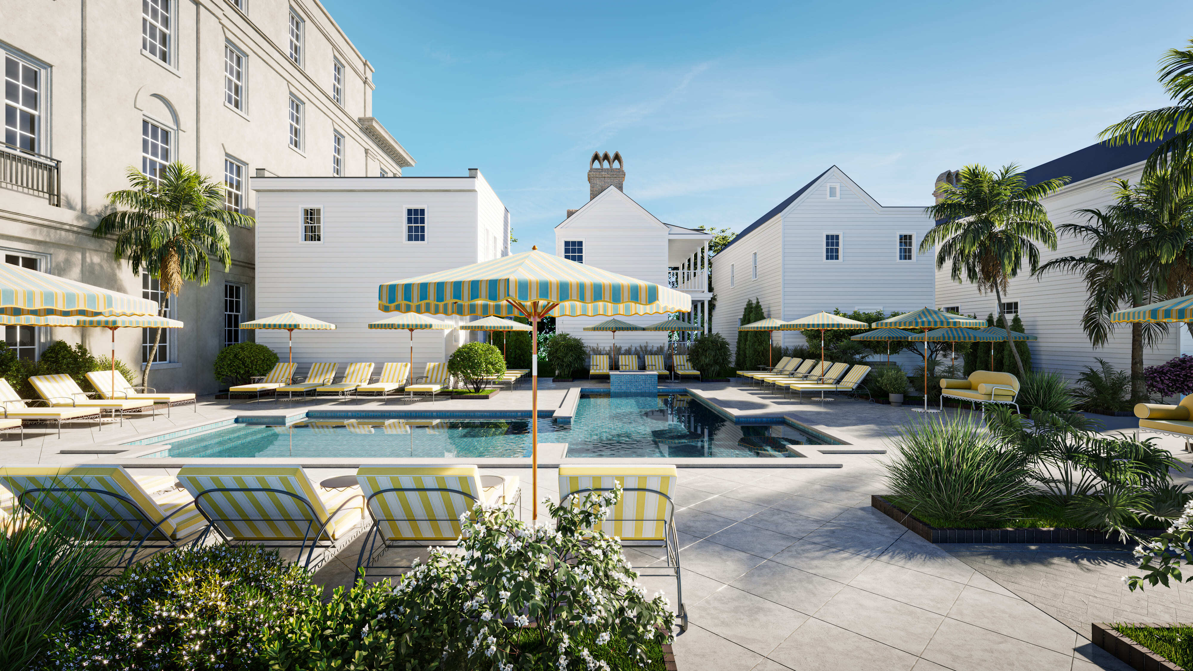 Charming communal pool area with elegant loungers, vibrant umbrellas, and lush greenery, perfect for relaxation and leisure.