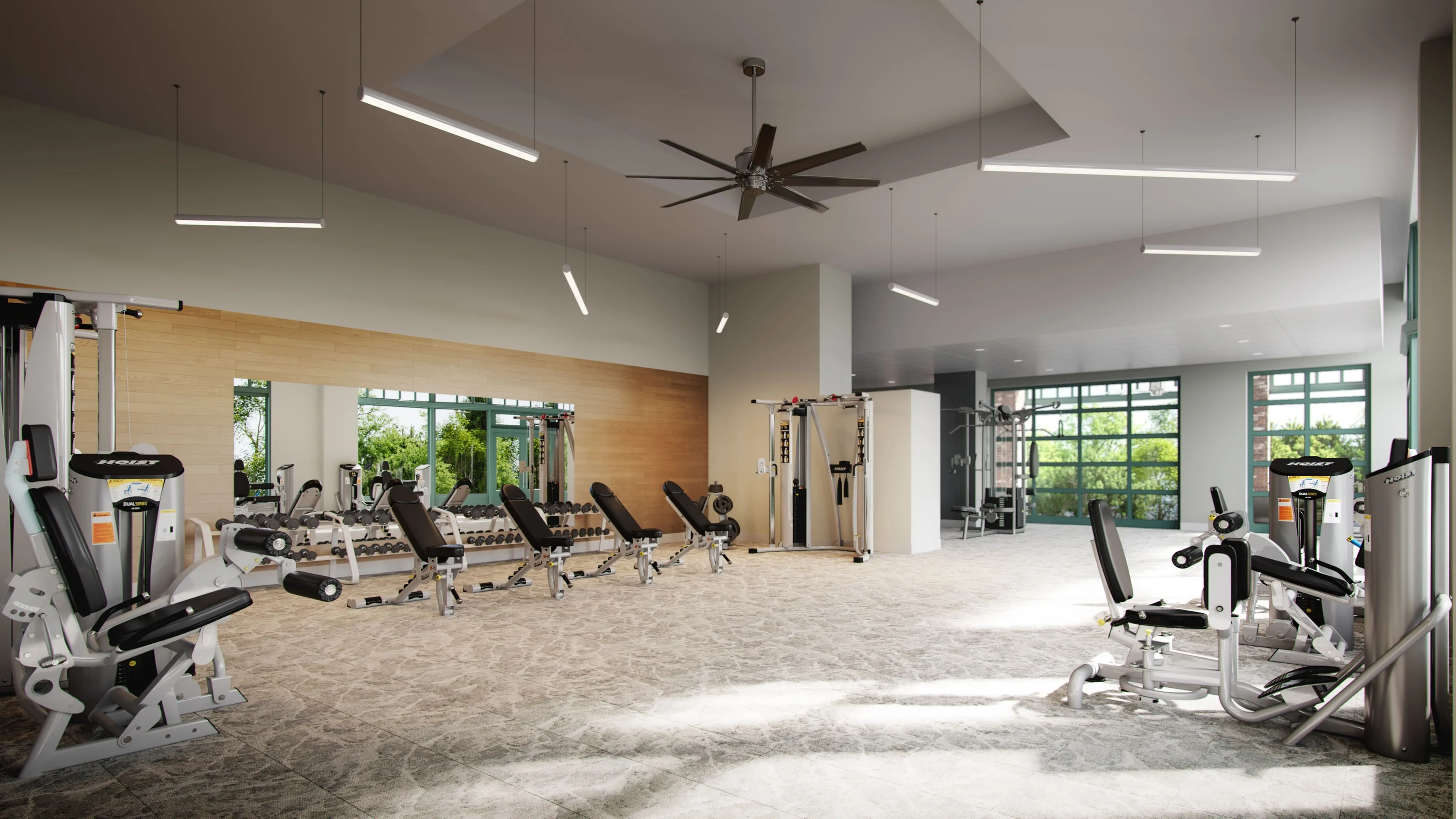 Spacious and modern fitness center with state-of-the-art gym equipment, bright natural lighting, and sleek design.