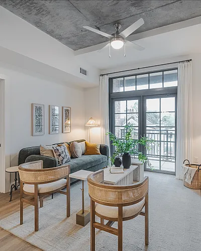 Chic modern living area with stylish decor, featuring a cozy bedroom, large windows, and elegant furnishings.