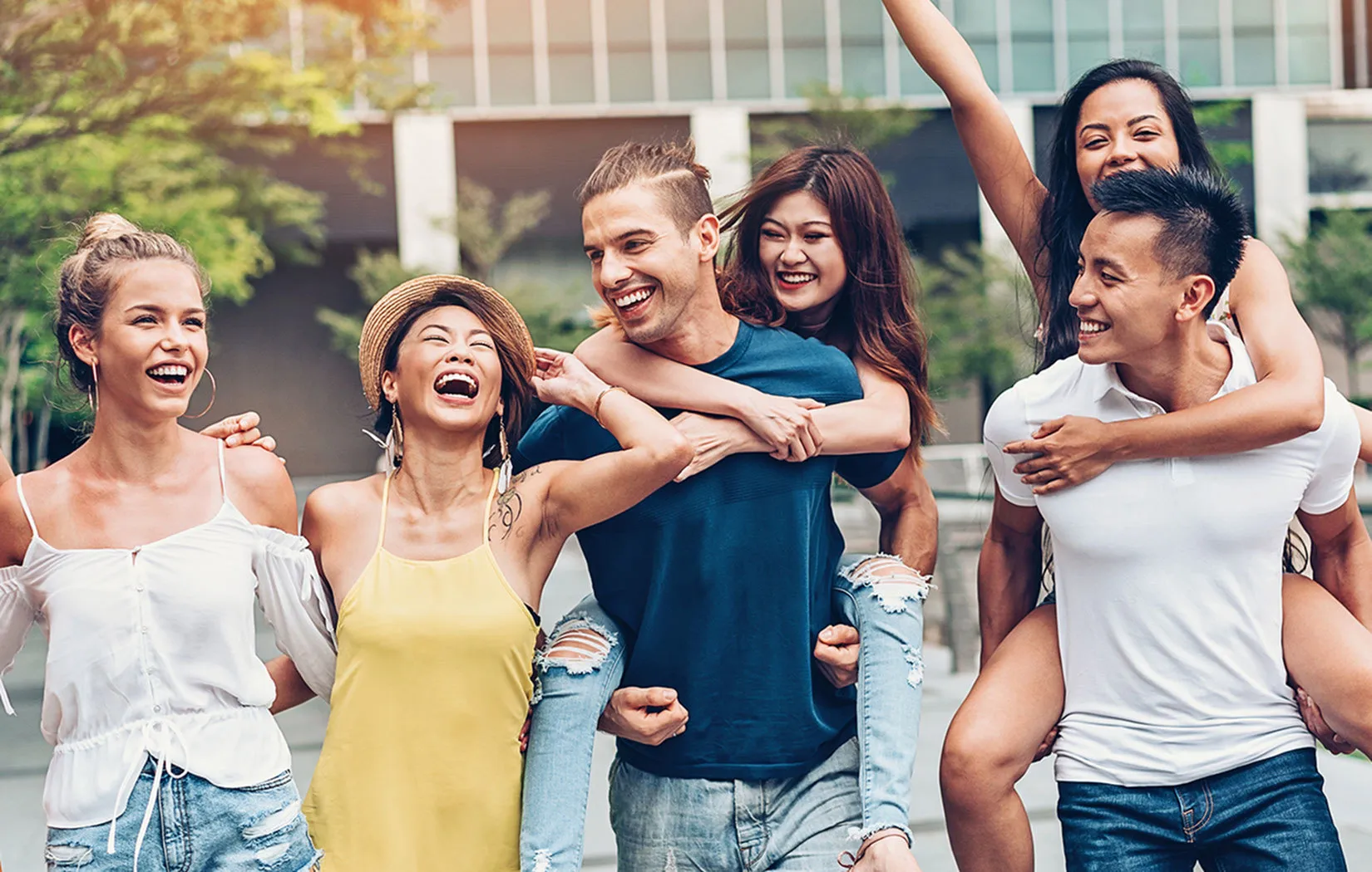 Joyful group of friends having fun outdoors, exuding happiness and camaraderie in a scenic urban setting.