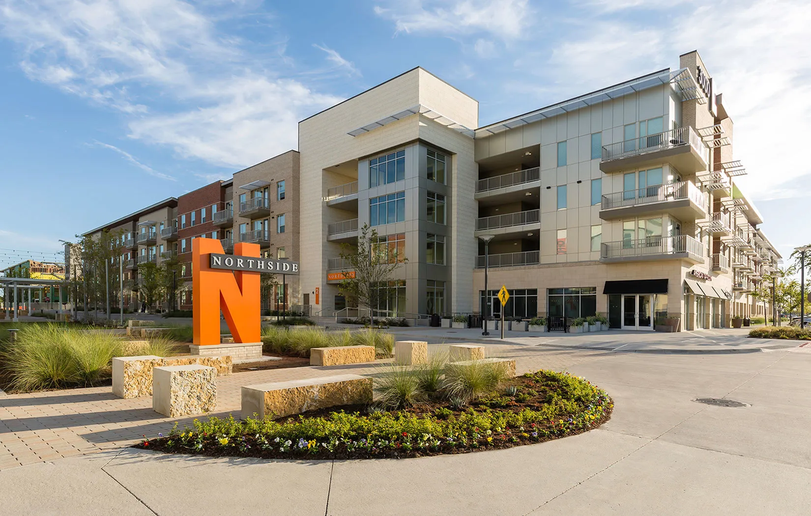Modern Northside apartment complex featuring elegant architecture, landscaped outdoor spaces, and convenient location.
