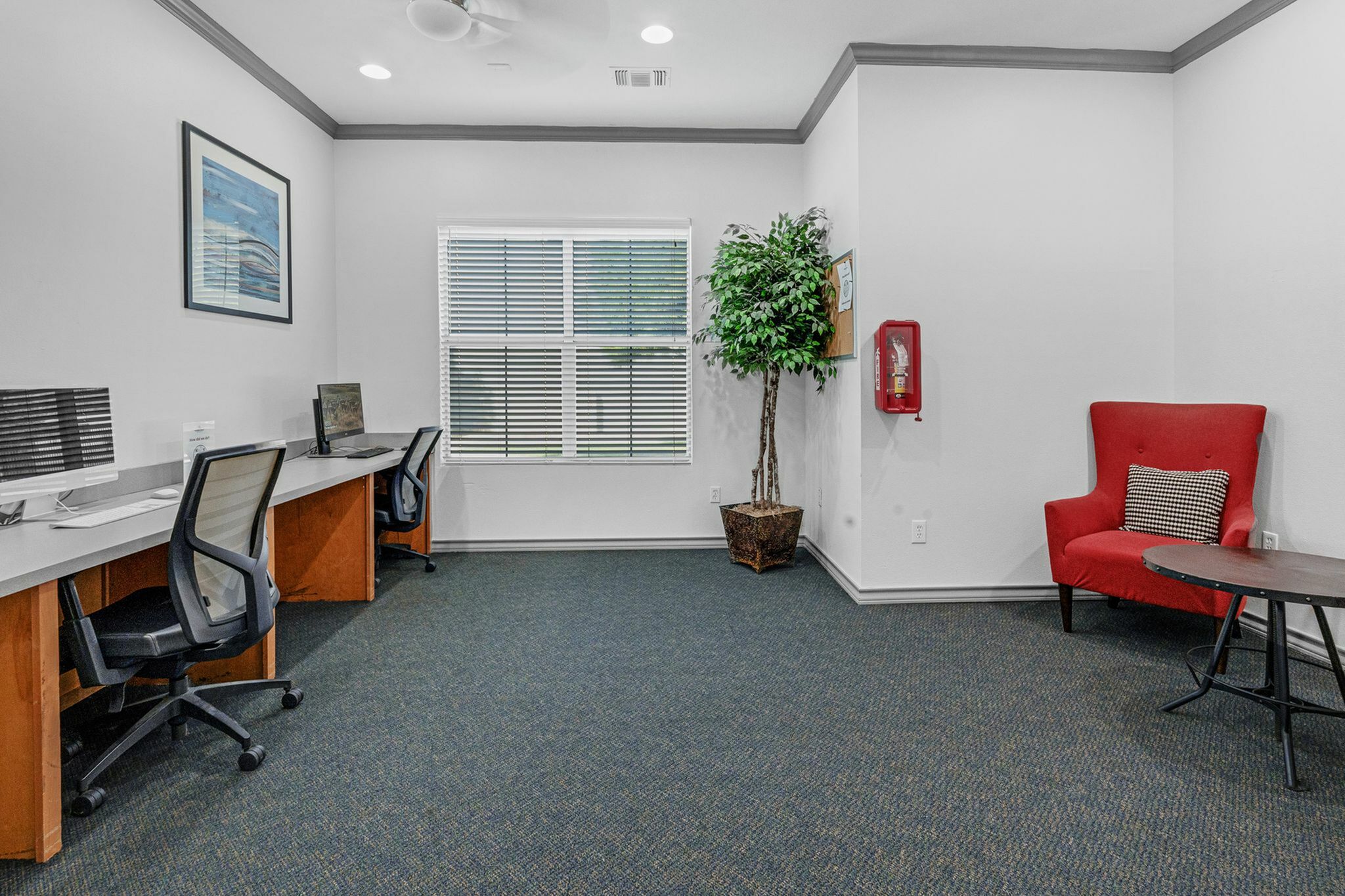 Business center with desks, chairs, and plenty of natural light