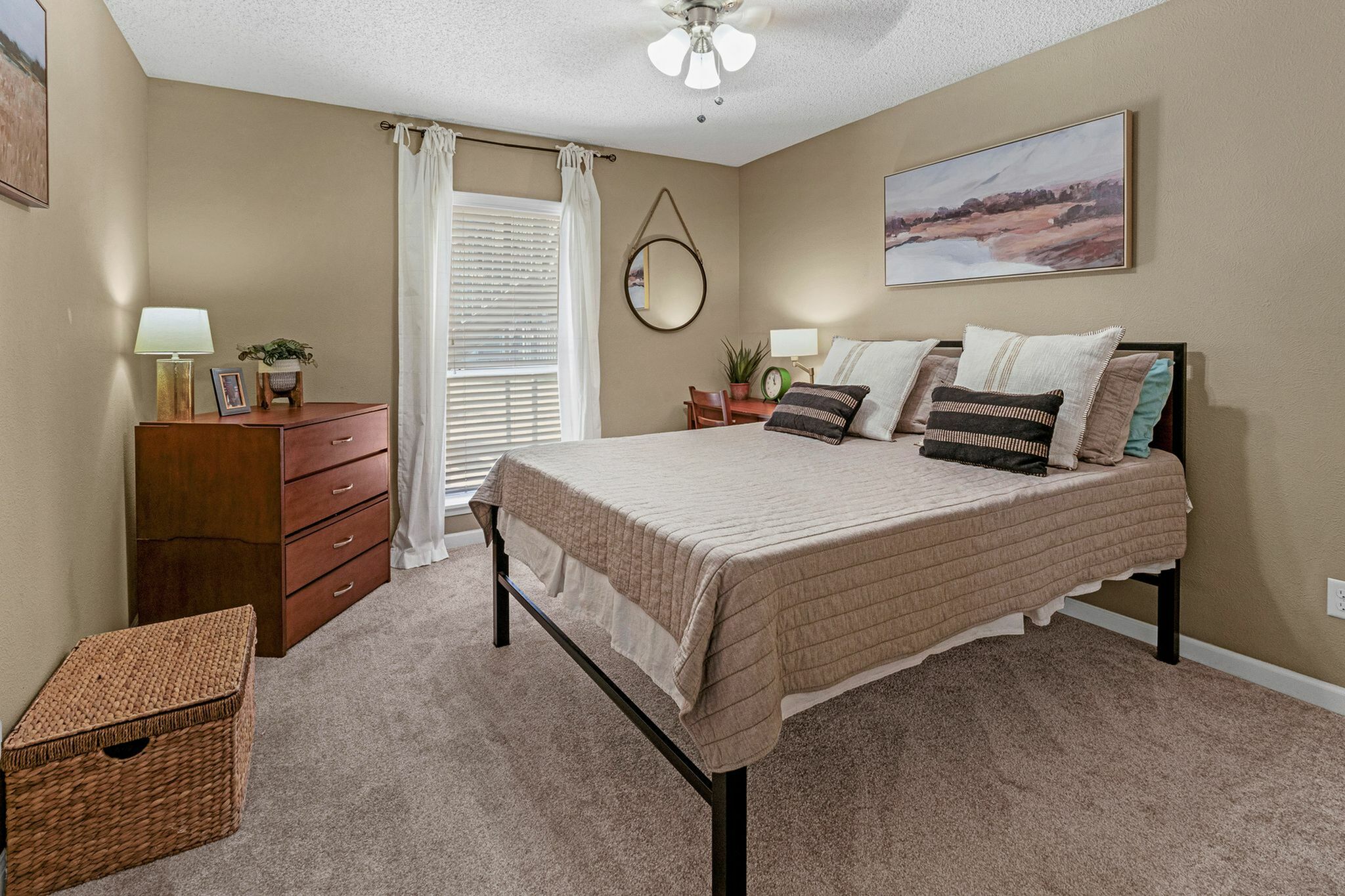 Modern bedroom with ample natural light at Raiders Walk apartments