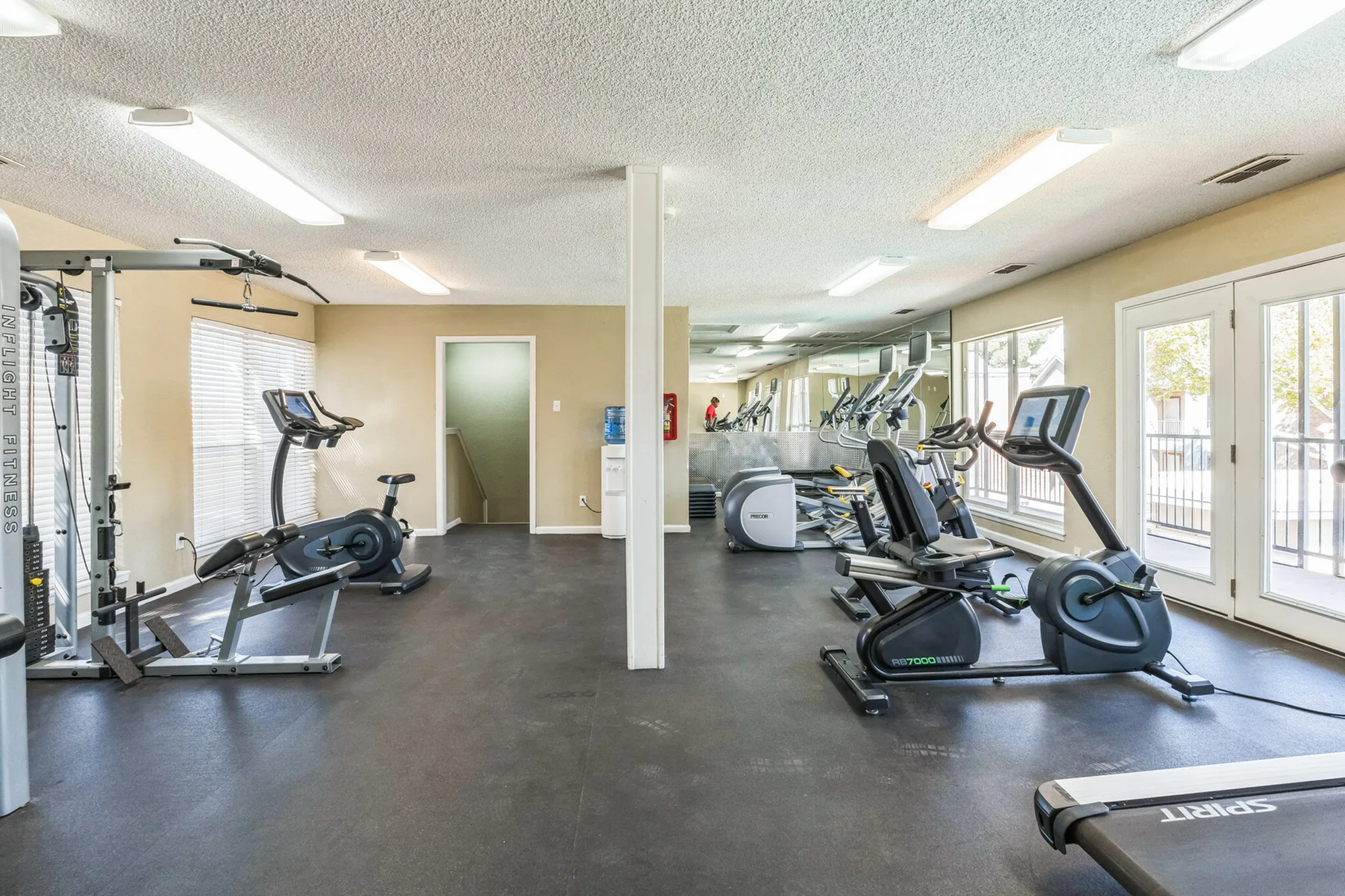 Fully equipped fitness center at Raiders Walk with a variety of exercise machines and free weights