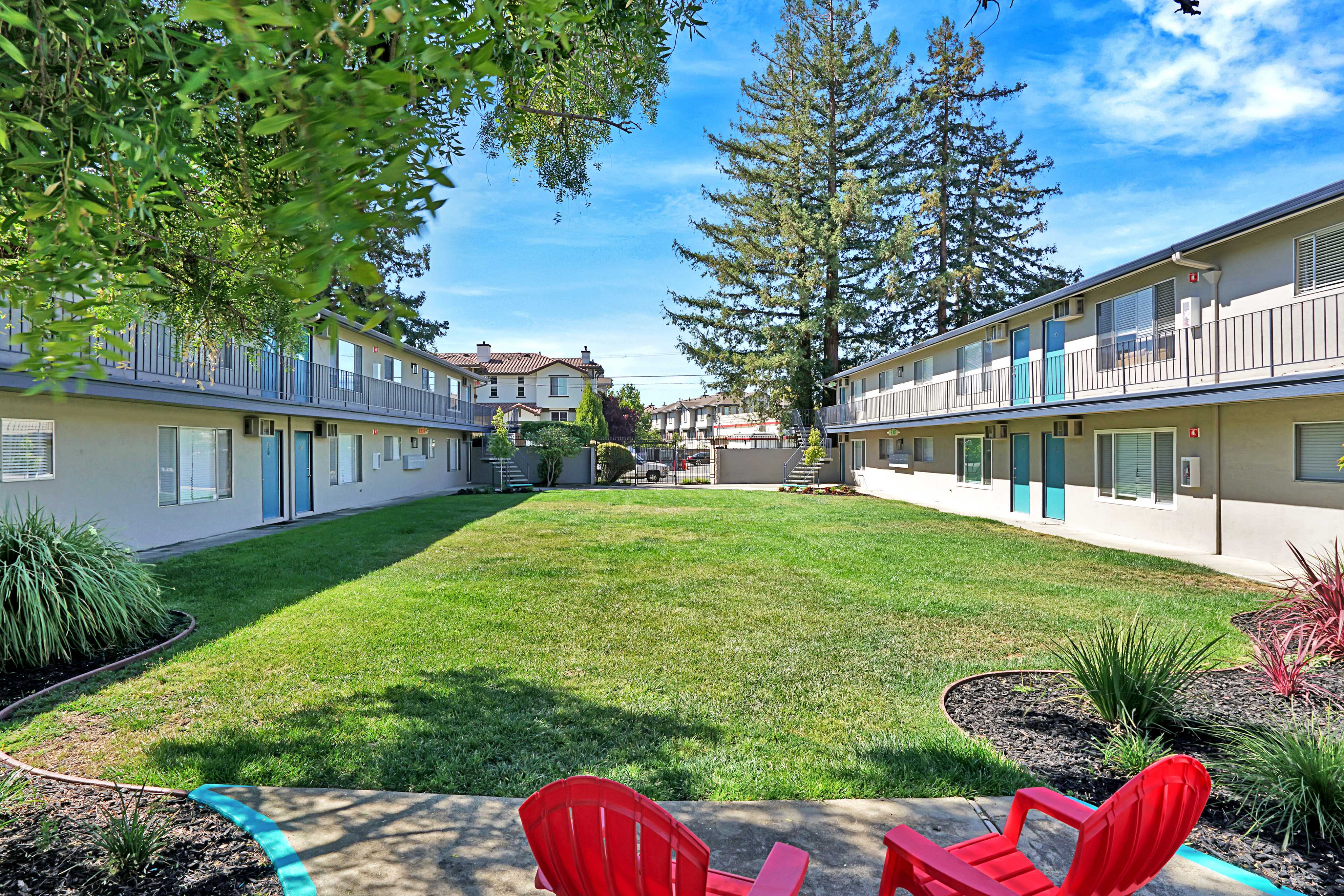 Courtyard with red chairs and controlled access gate