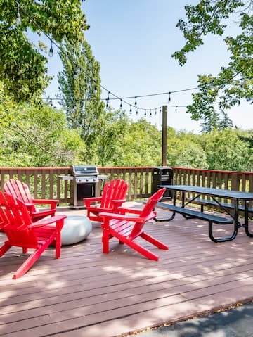 red Adirondack chairs and a picnic bench on a patio