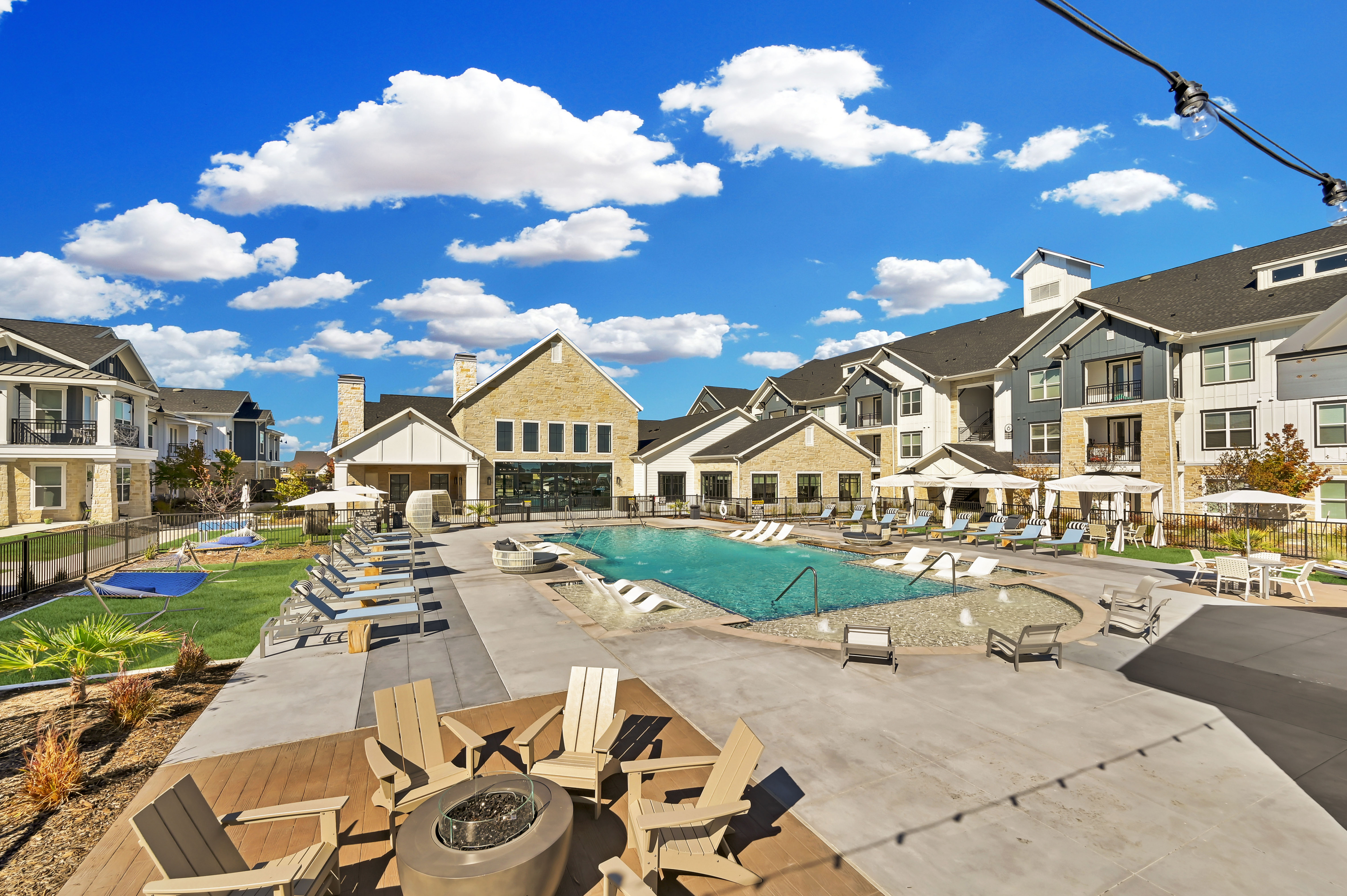 pool with lounge chairs and outdoor fire pit with seating