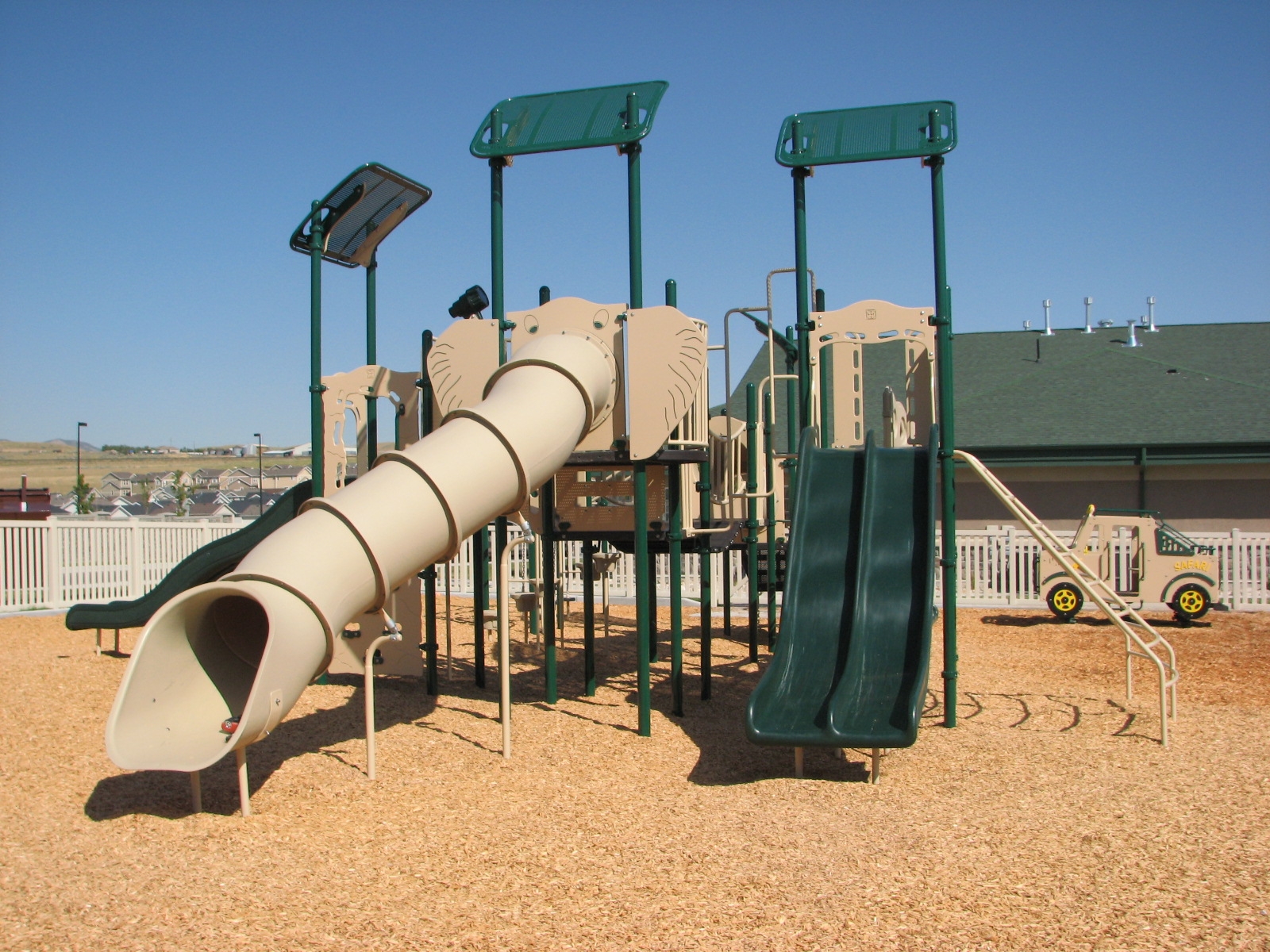 Vibrant playground with slides, climbing features, and a tube slide, perfect for family fun.