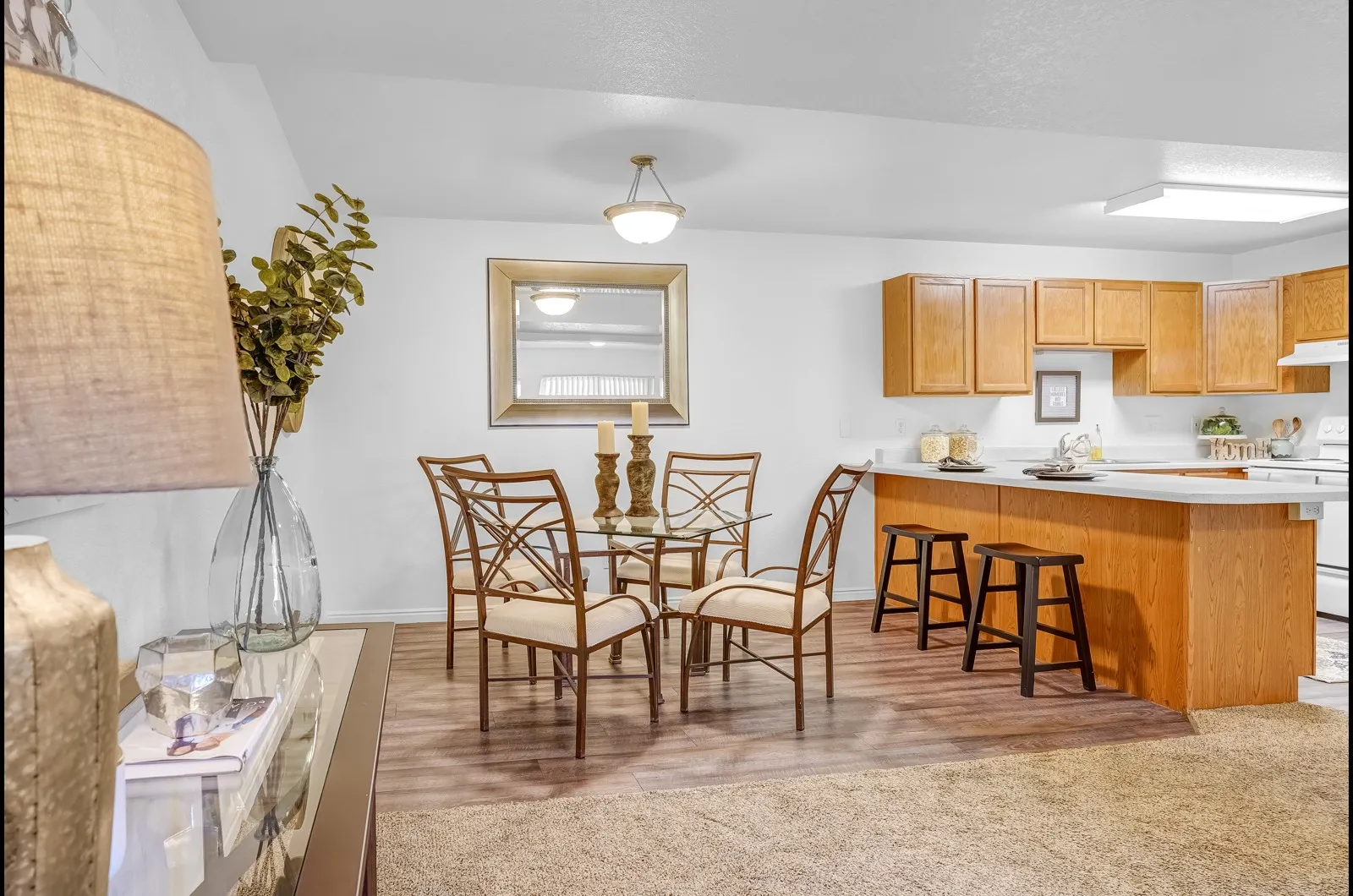 Kitchen and dining room interior with furniture and mirror on the wall