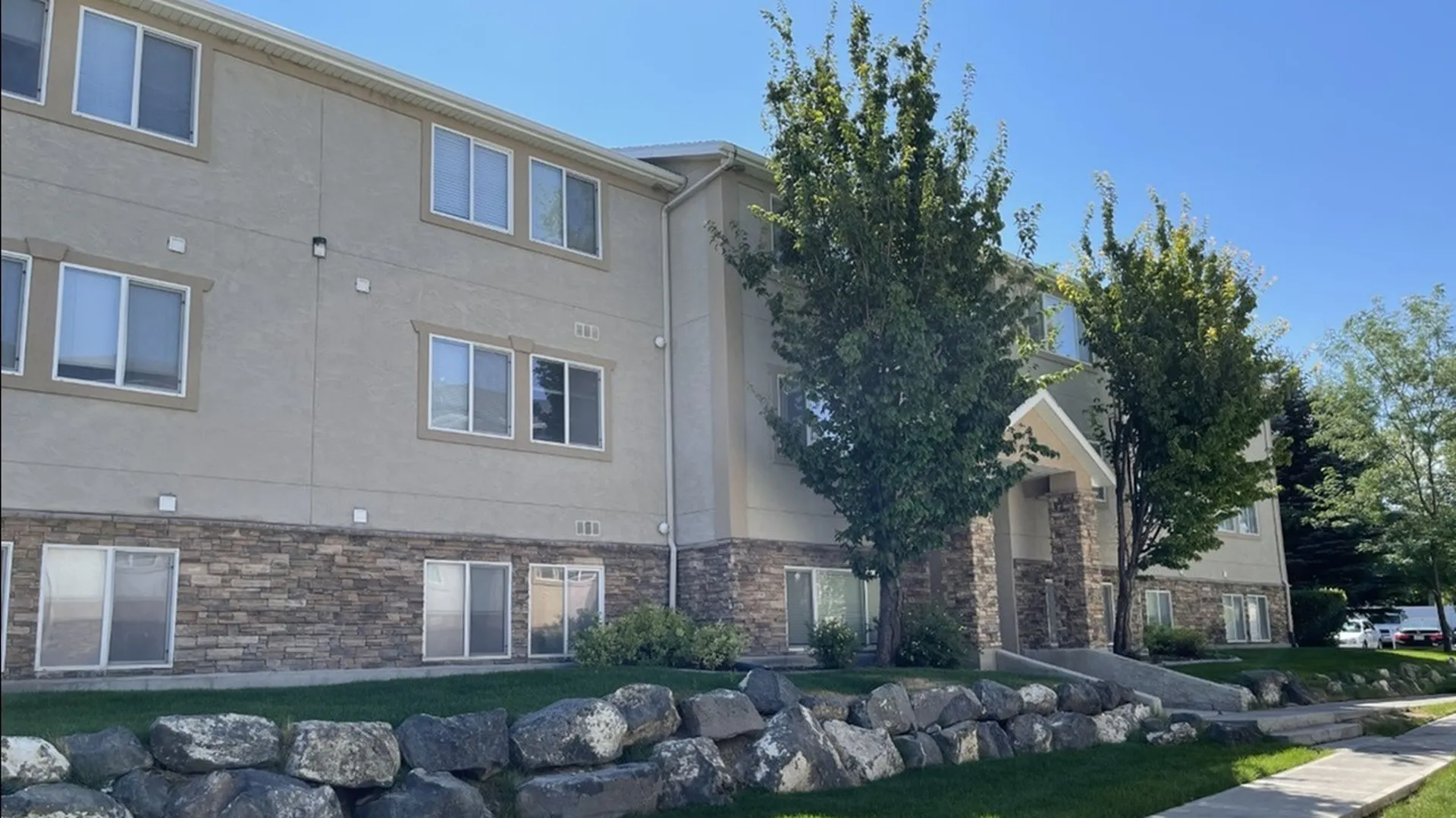 Exterior Apartment Building with trees, grass, and steps