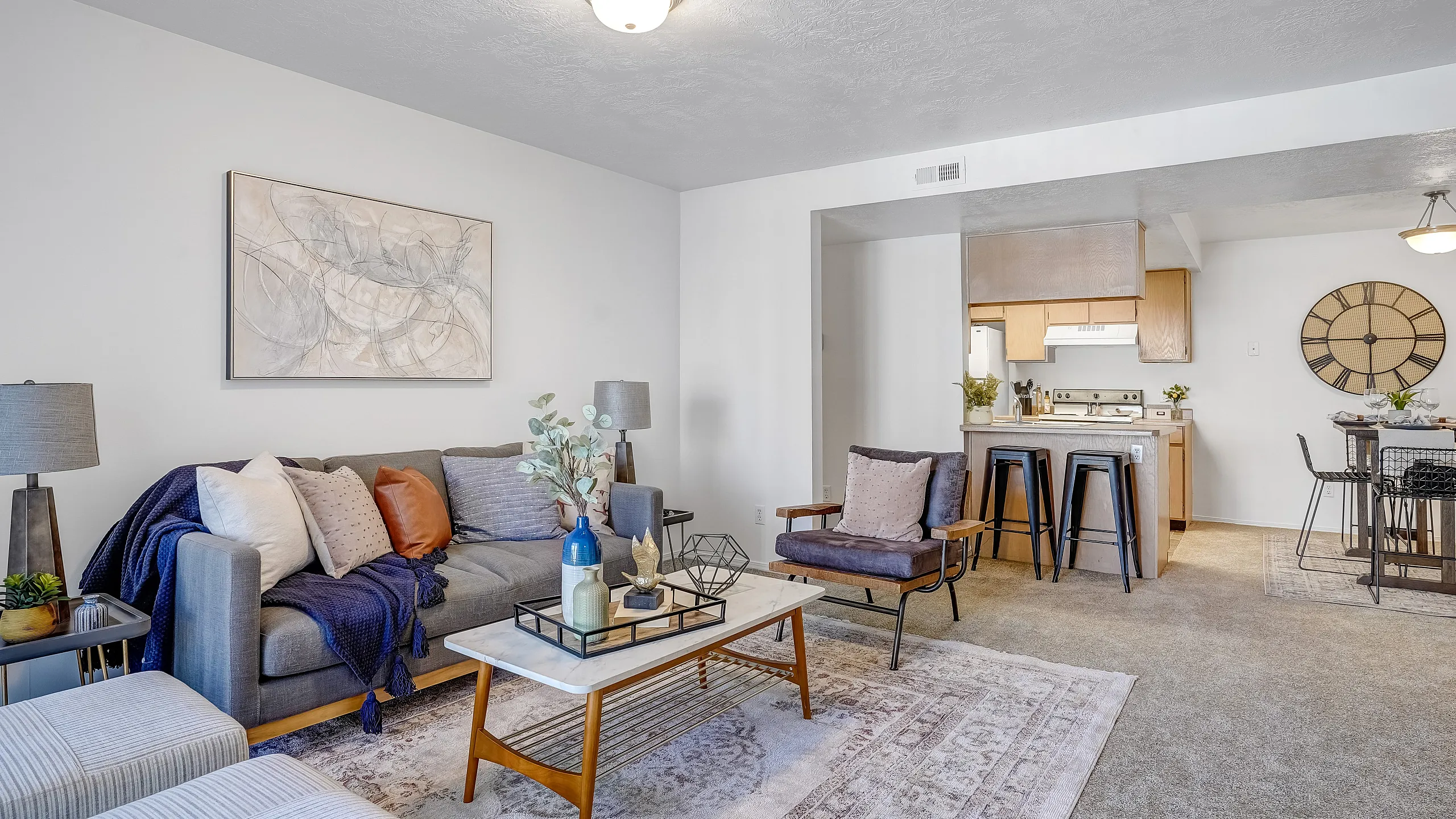 Inviting open living space with stylish decor, comfortable seating, and a view into the kitchen and dining areas.