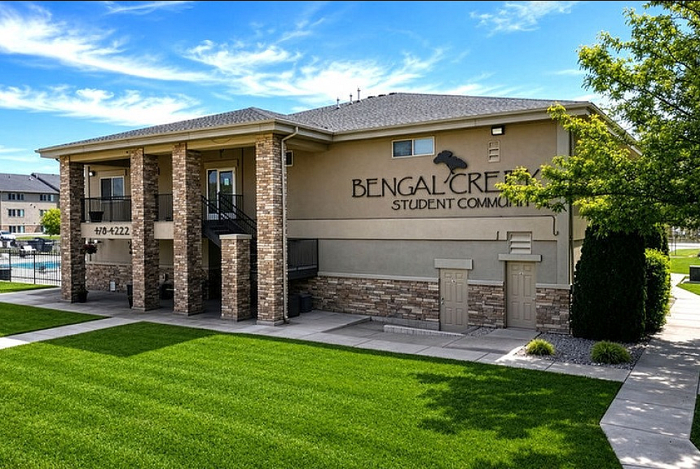 Inviting exterior view of Bengal Creek Student Community, showcasing modern architecture and lush green landscaping.