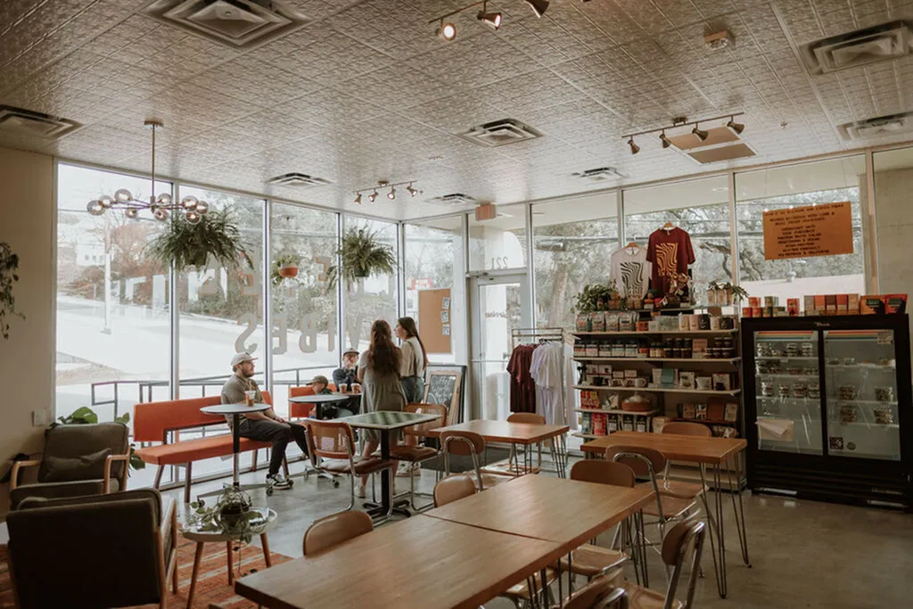 Inviting café interior with modern seating, product displays, and large windows allowing natural light.