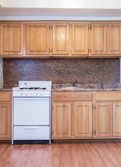 kitchen with white range and tile backsplash at middle branch