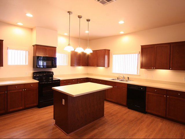3-bedroom SO home, large ktichen with cherry cabinets and black appliances