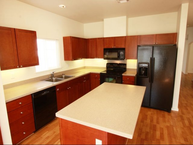 4-bedroom new single family home, large kitchen with black appliances