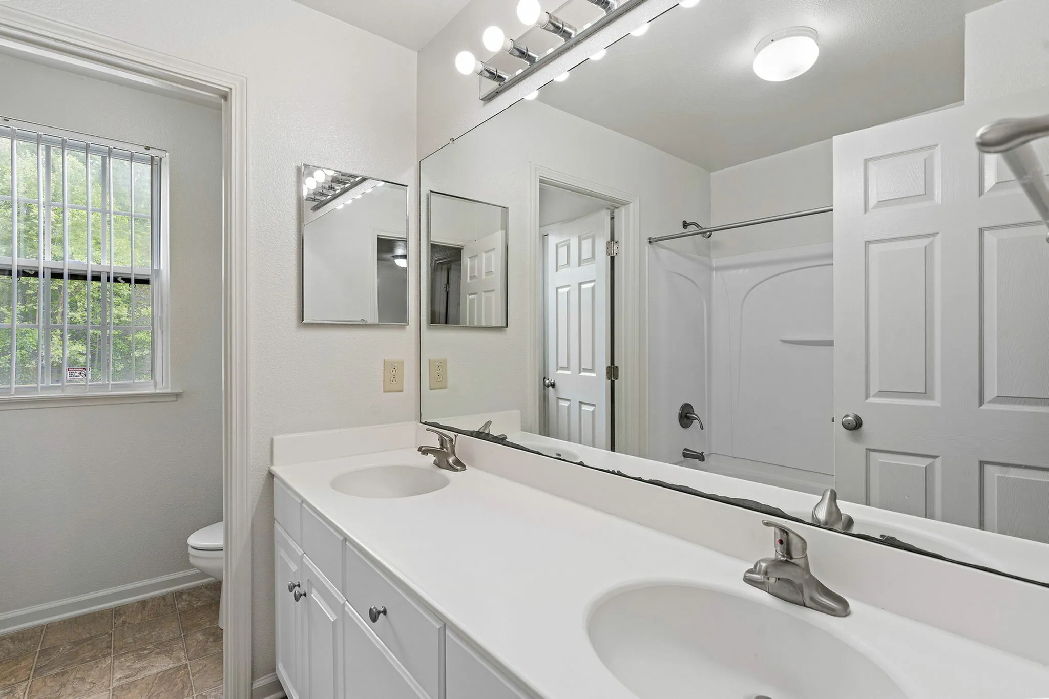 Full bath with double-sink vanity.
