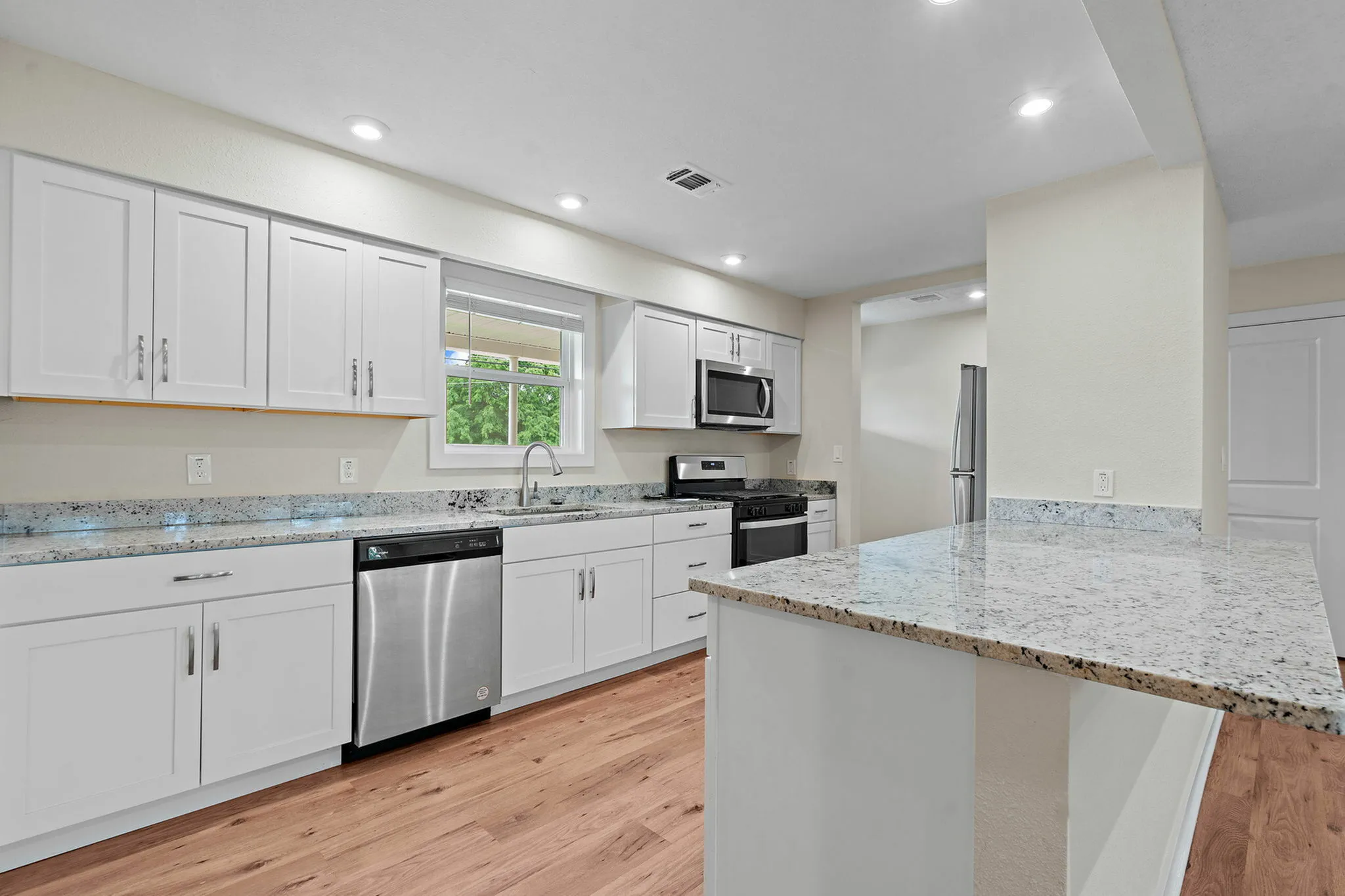 Enjoy cooking in your fully equipped kitchen with new cabinets and counter tops