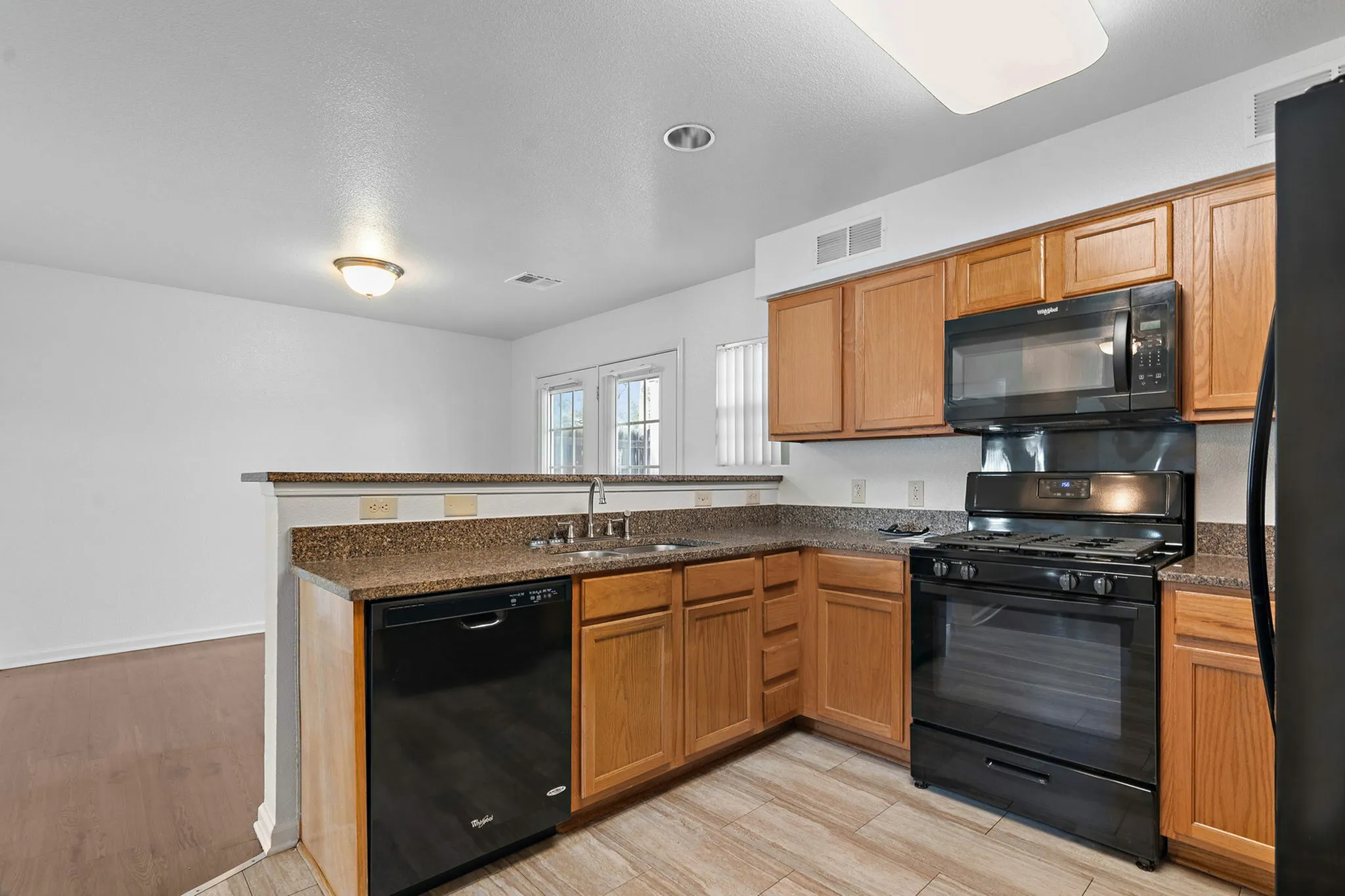 Includes black appliances and granite countertops