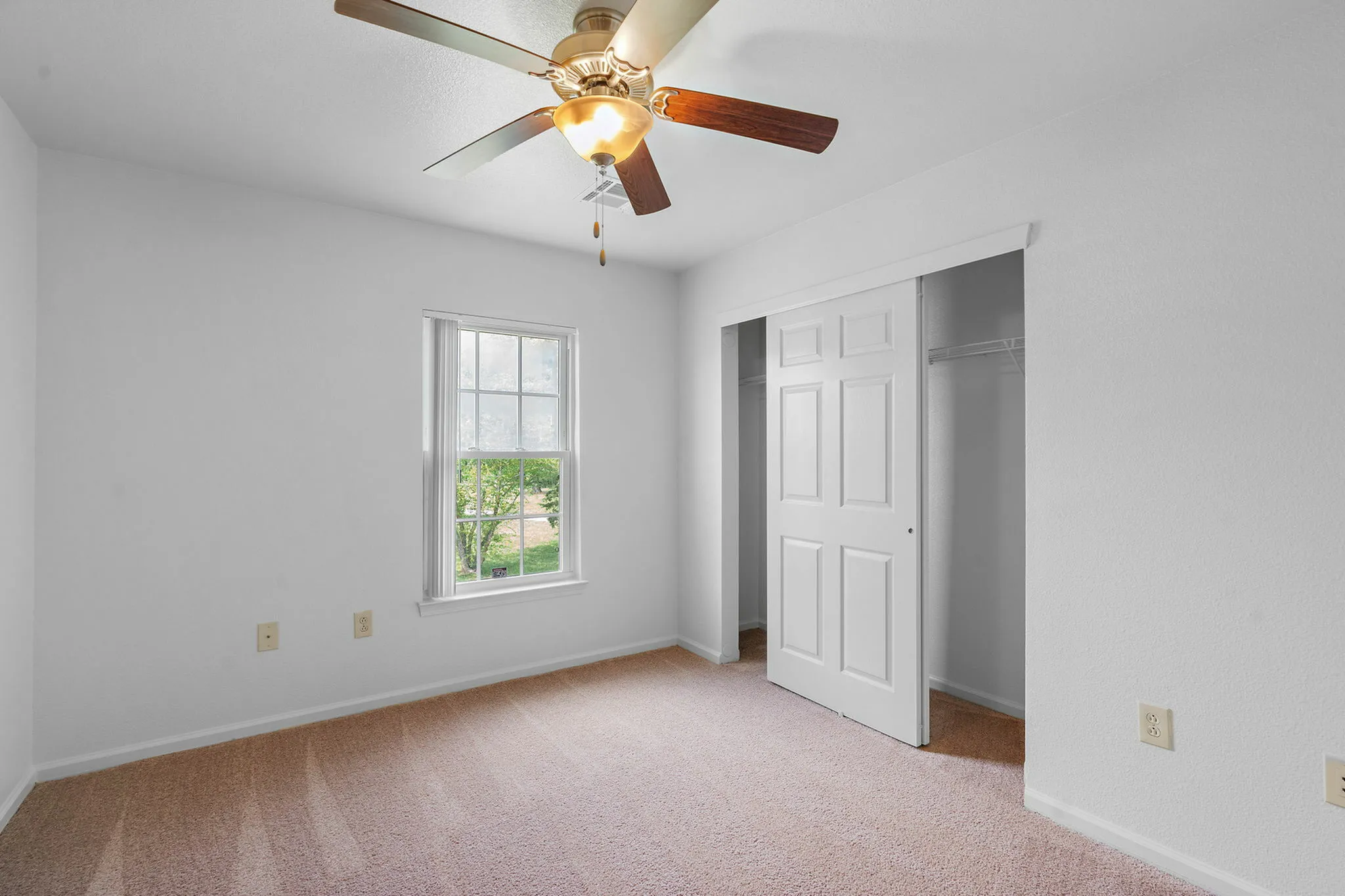 Large room with double closets and ceiling fan