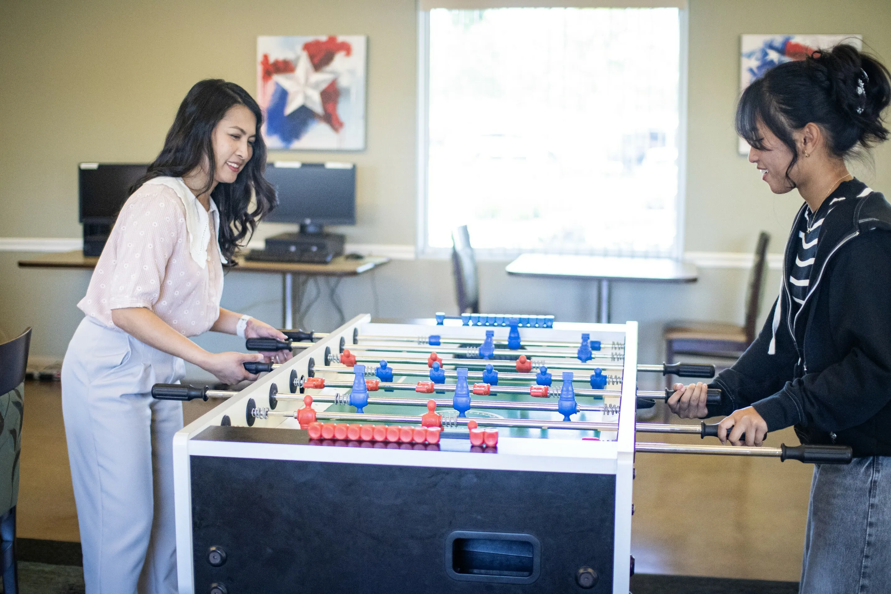 Women Playing foosball at a Cavalry Family Housing Community center