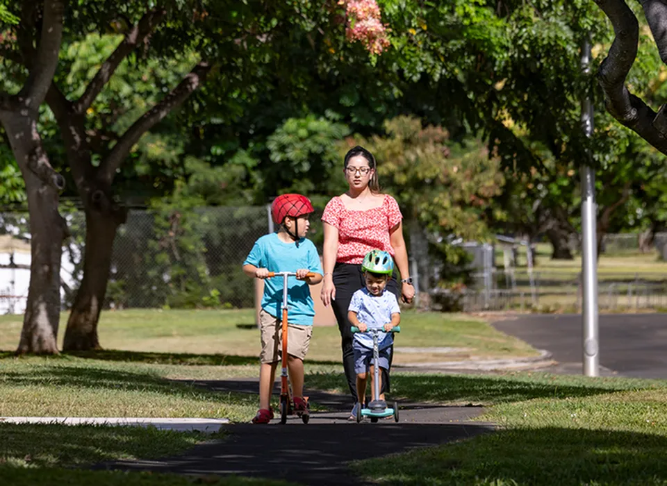 Family walking on walking paths at Hickam Communities
