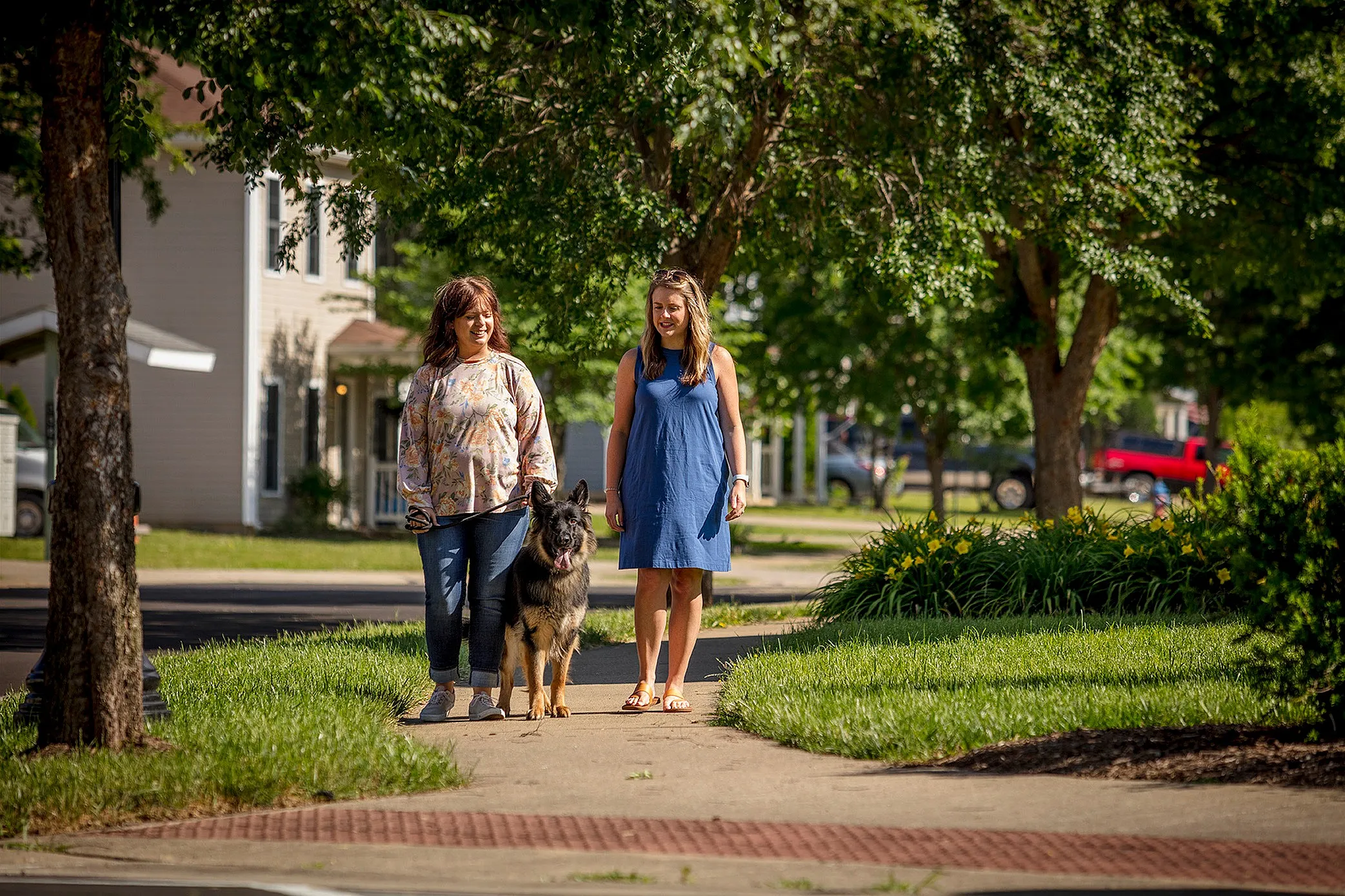 two women walking a dog