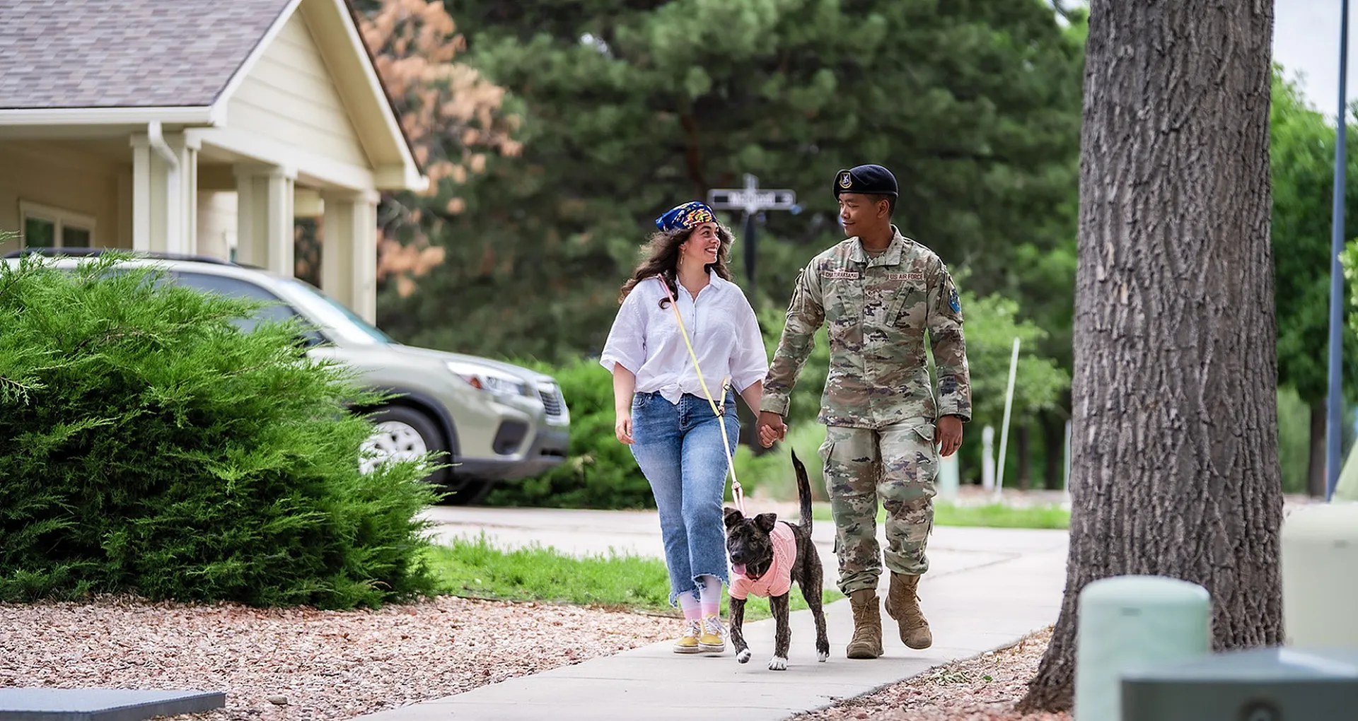 man and woman walking a dog
