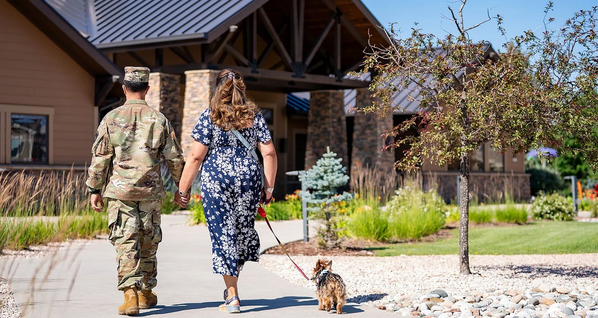 two adults walking a dog