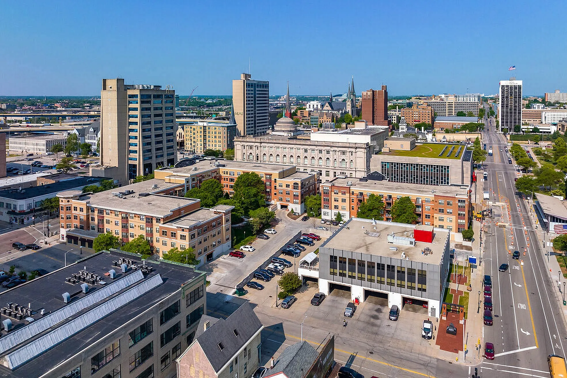 Vibrant cityscape showcasing modern apartments amidst downtown skyline, highlighting urban convenience and lively atmosphere.