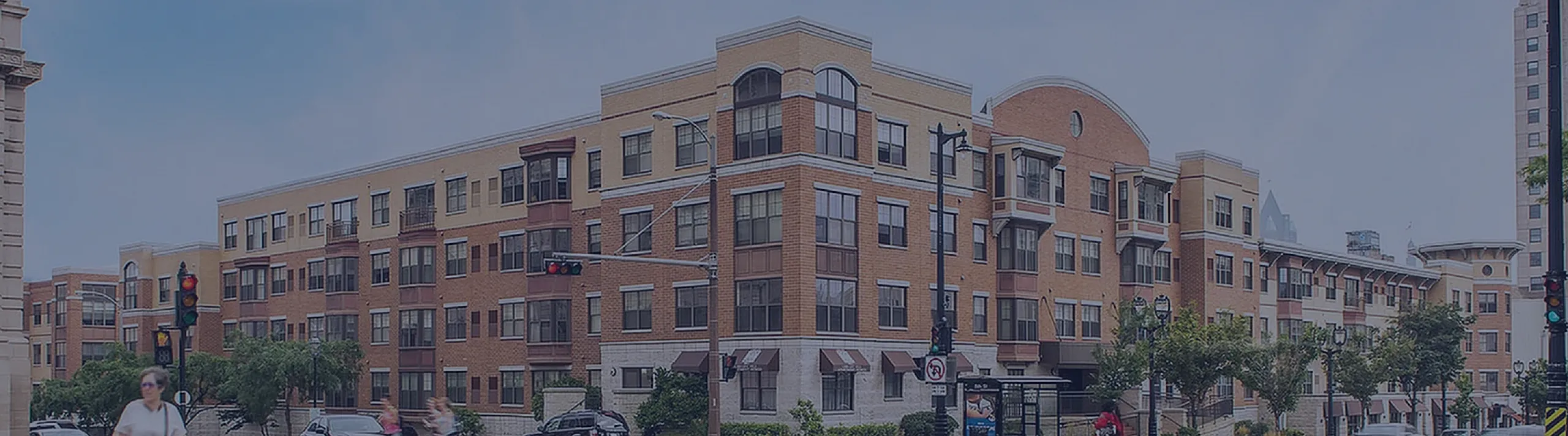 Charming urban apartment building with classic architecture, located on a vibrant city street corner.