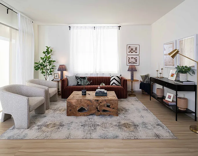 Inviting living room with a modern aesthetic, featuring a plush sofa, unique wooden coffee table, and elegant decor accents.