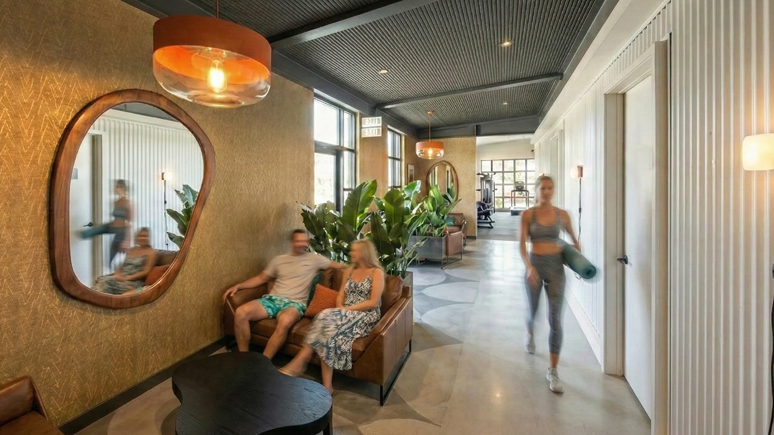Elegant lounge area with modern decor, cozy seating, lush greenery, and ambient lighting, perfect for relaxation and socializing.