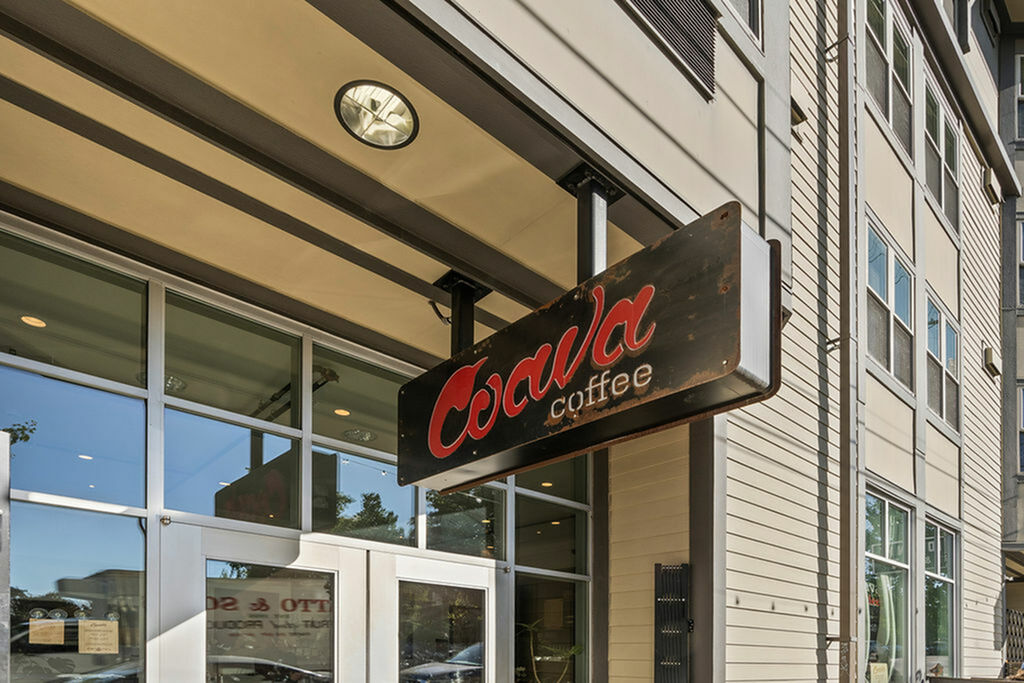 Charming Coava Coffee shop entrance with modern glass doors and building facade