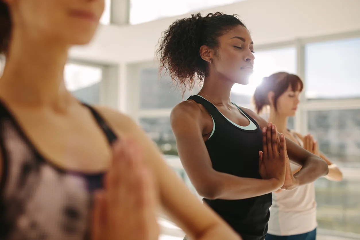 Women in fitness center doing yoga