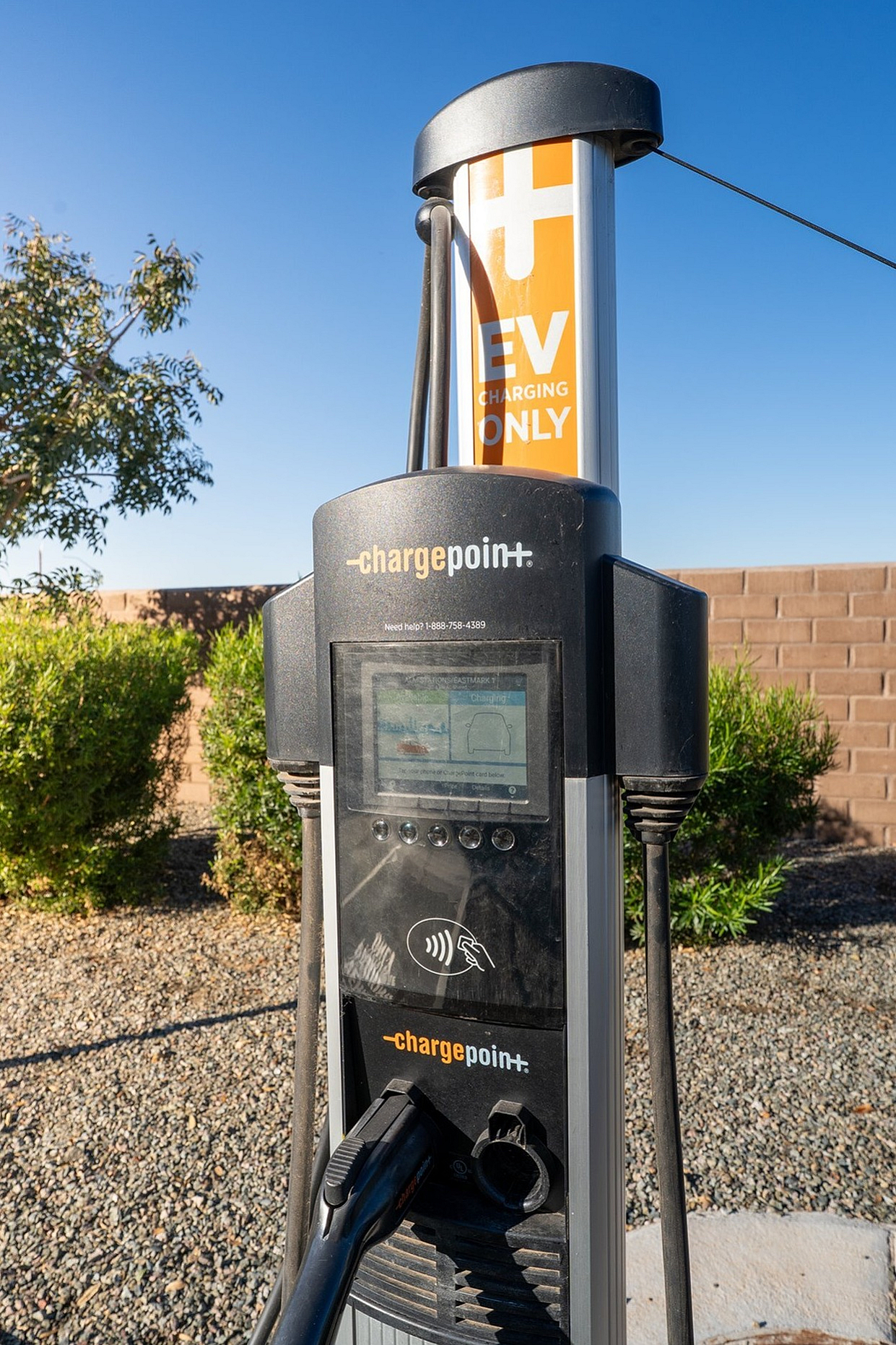 Modern EV charging unit in a landscaped area.