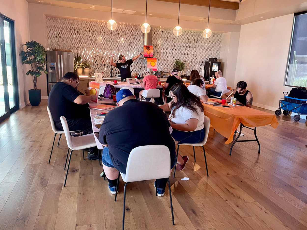 Vibrant community space with natural light, modern decor, and engaged residents enjoying creative activities in queen creek arizona