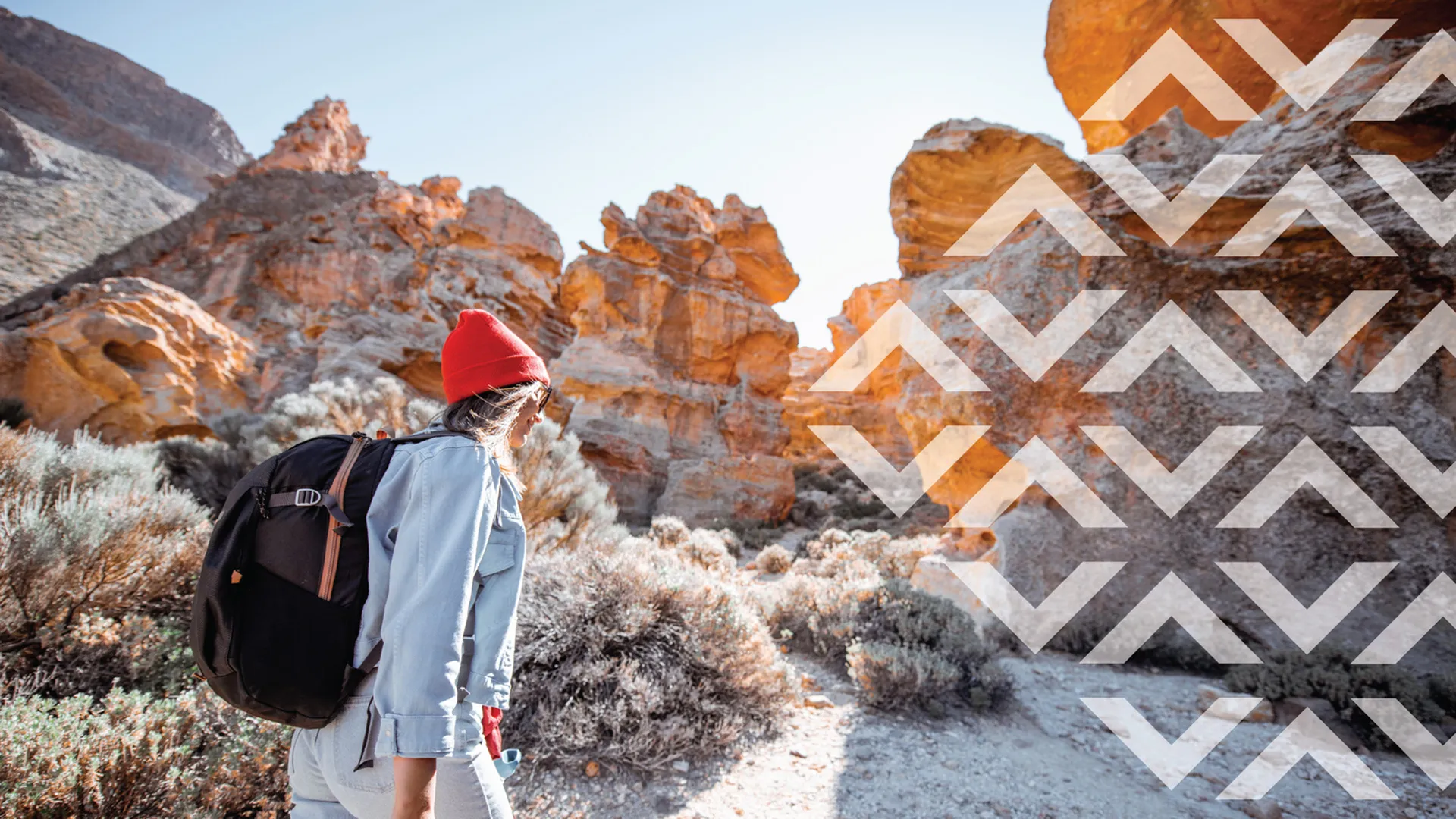 woman walking by rocking cliff in arizona