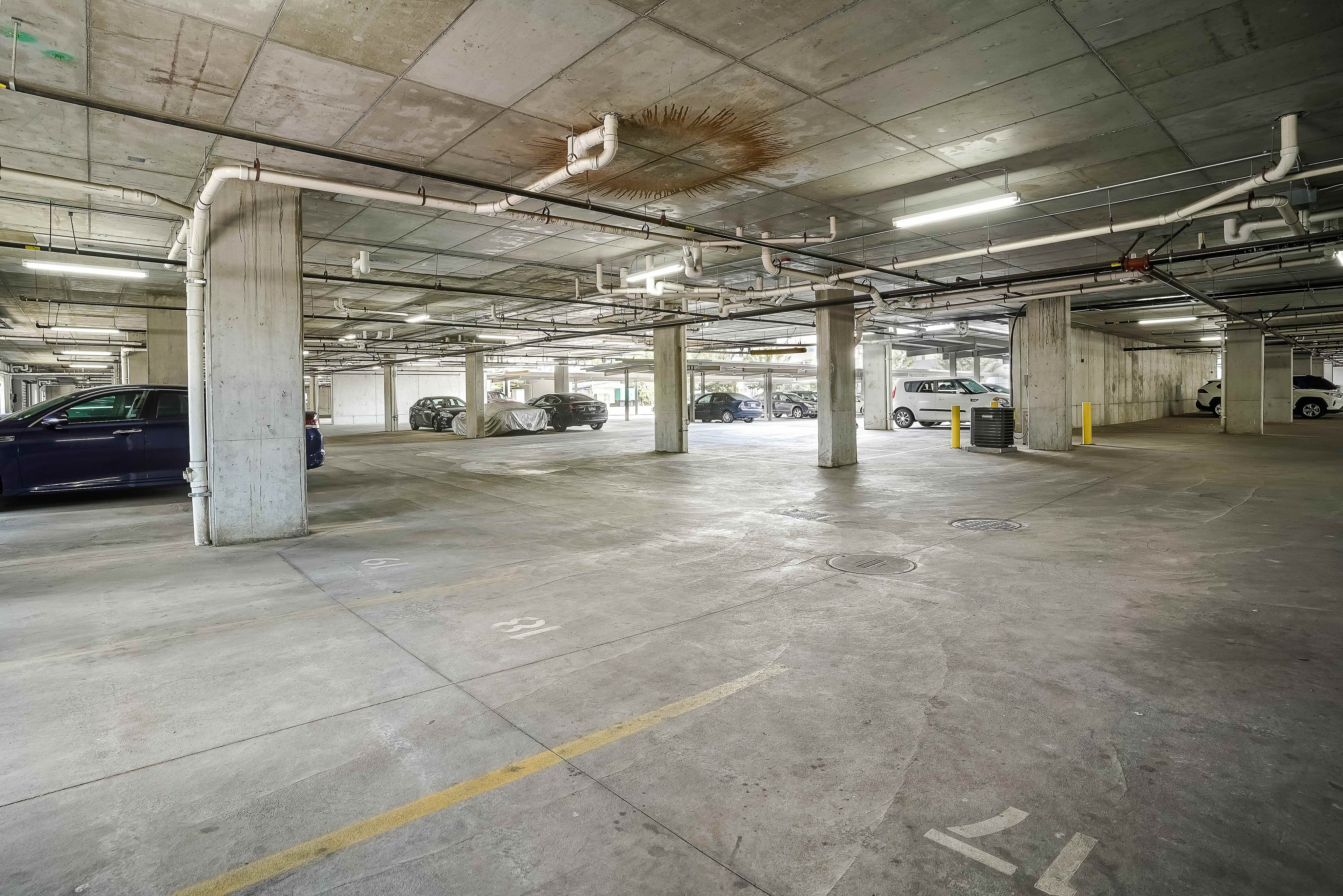 Modern underground parking garage with ample space and natural lighting.