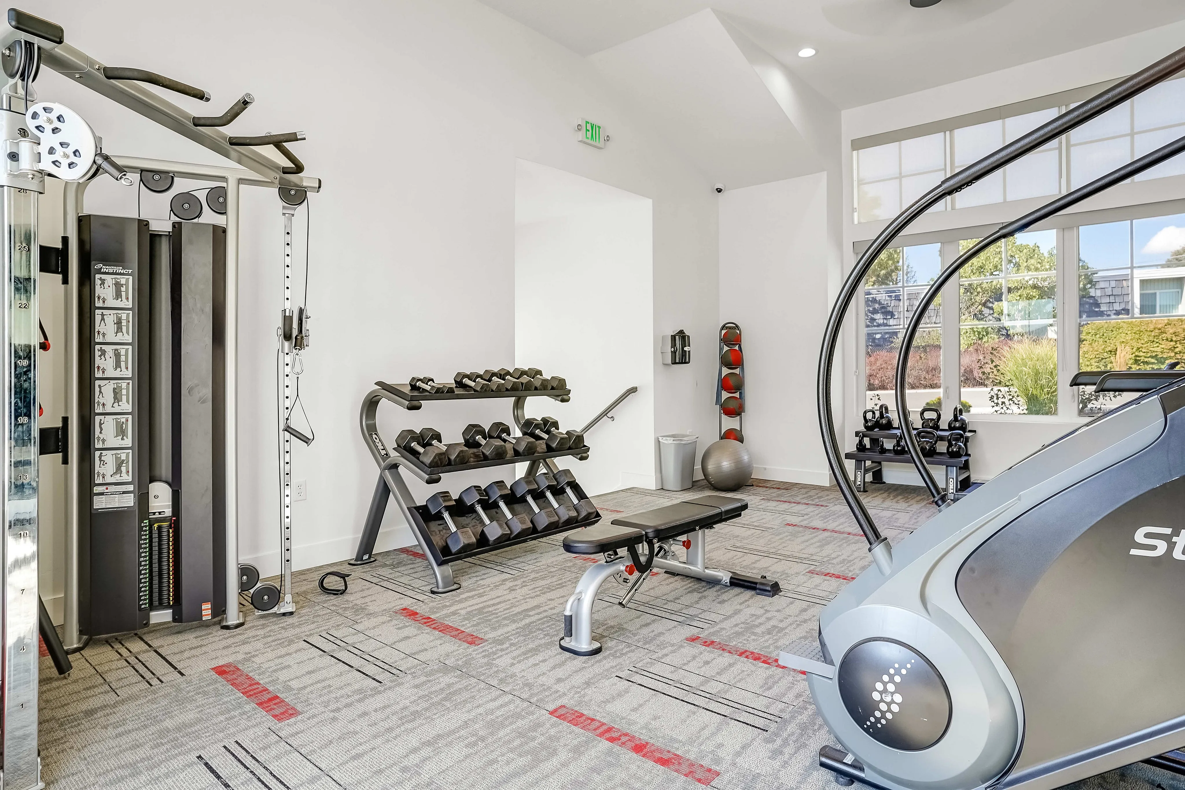 Modern fitness center with sleek gym equipment, bright windows, and a welcoming atmosphere for an energizing workout experience.