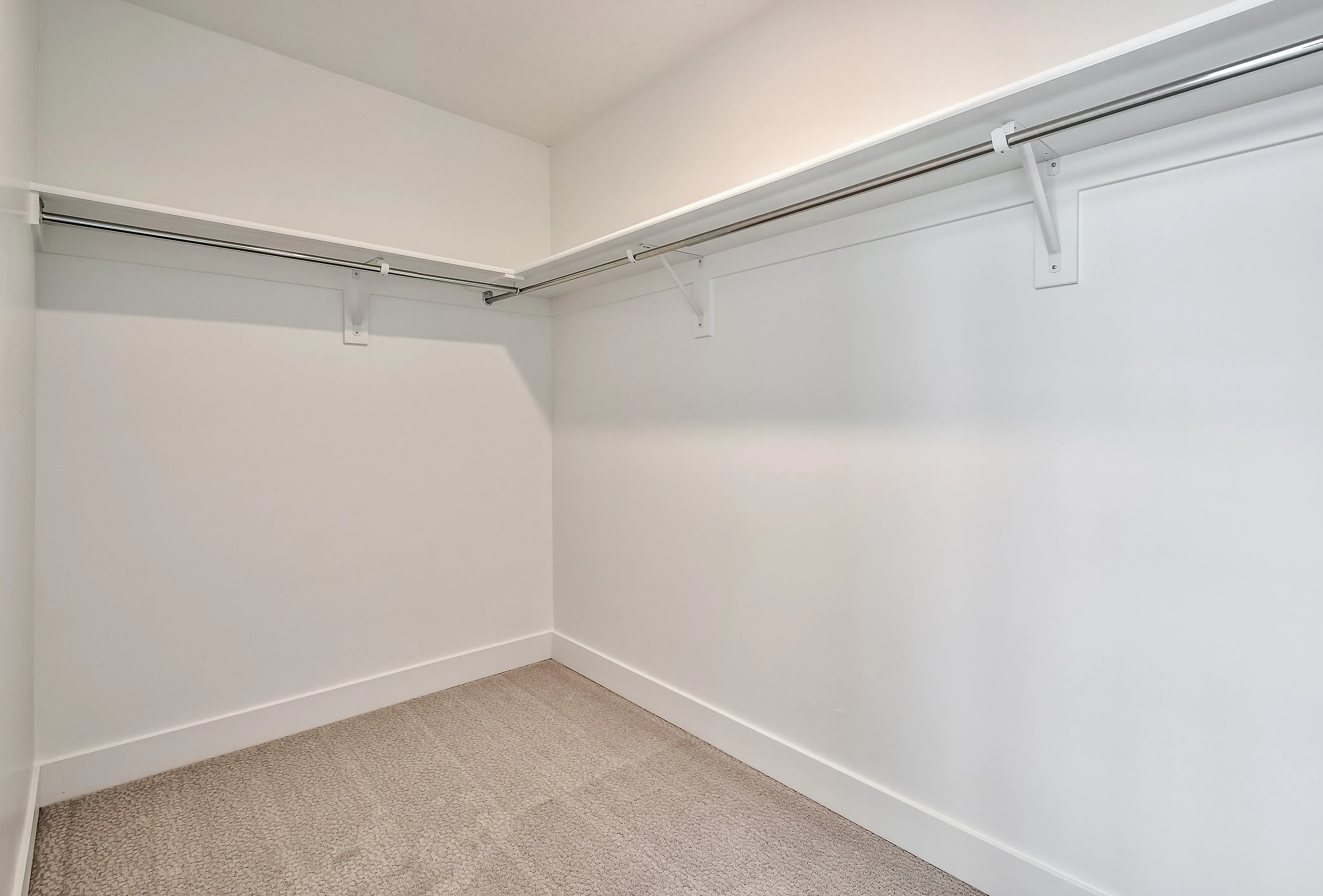 Spacious walk-in closet with modern shelving and ample storage space.