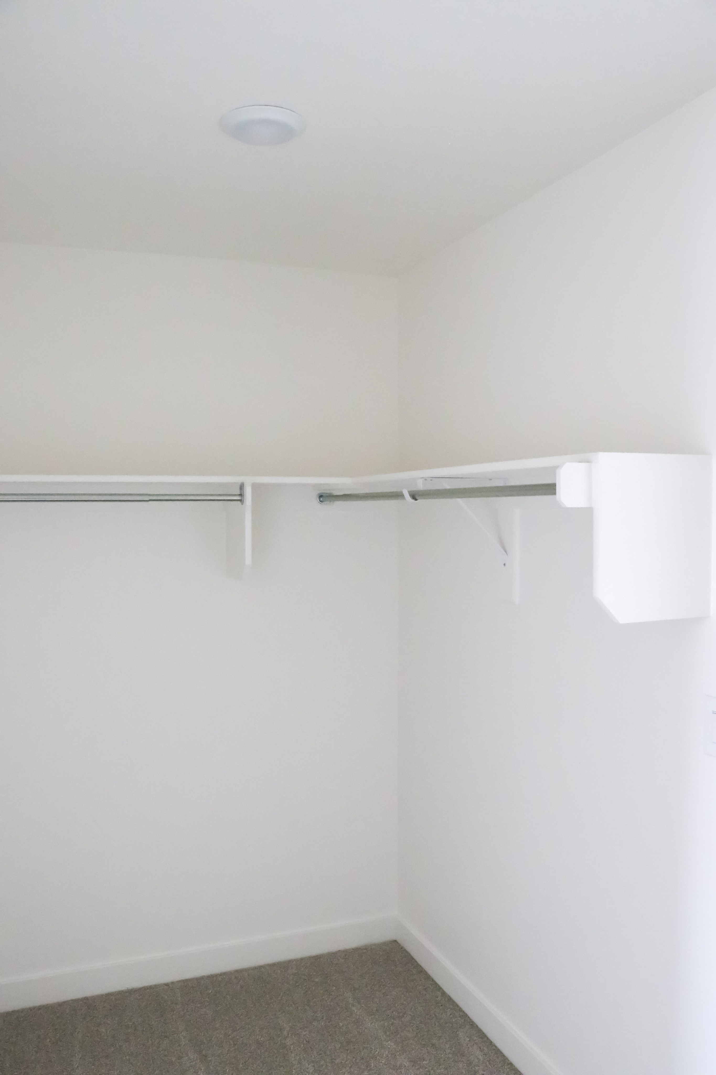 Bright and spacious walk-in closet with ample shelving, perfect for stylish organization.