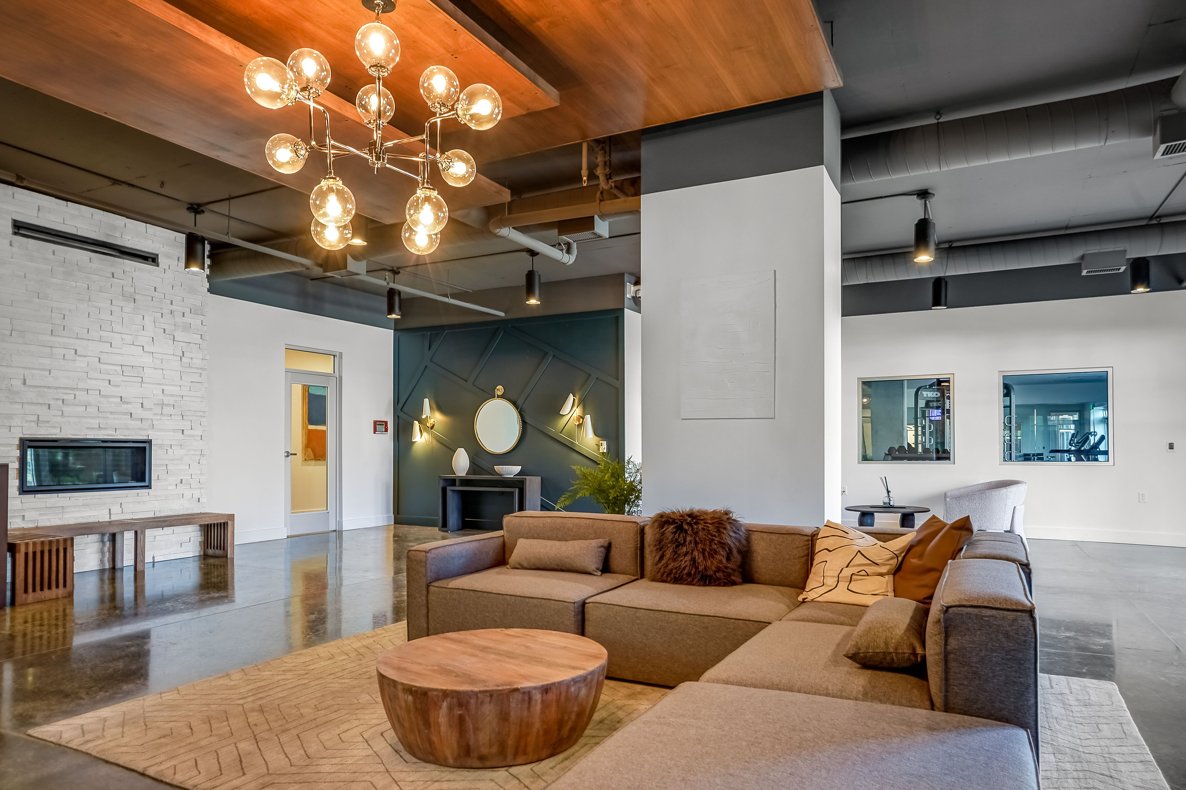 Luxurious open living space featuring modern lighting, chic furniture, and a cozy ambiance perfect for relaxation.