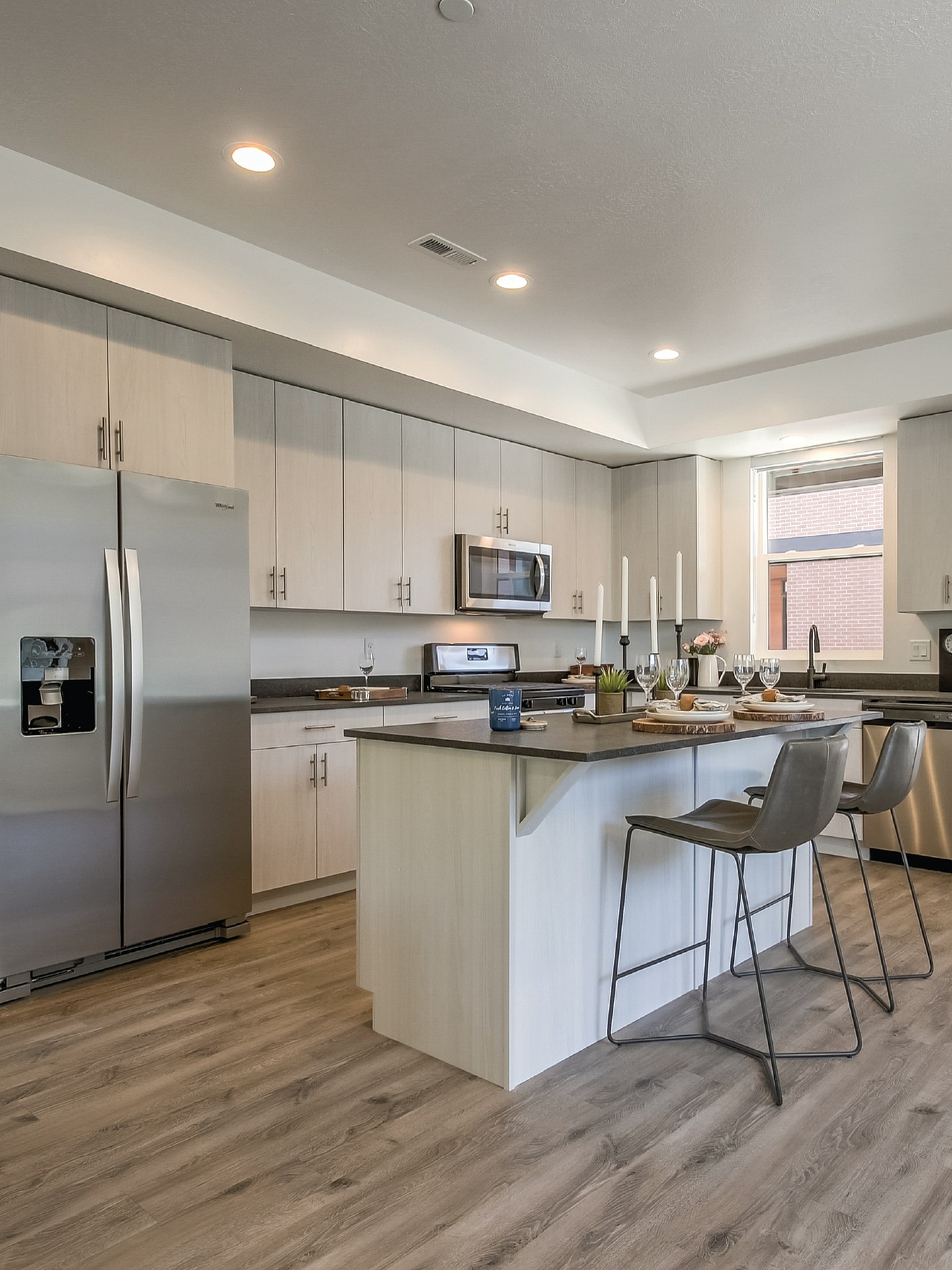 Modern kitchen with sleek stainless steel appliances, elegant island seating, and contemporary cabinetry, ideal for stylish living.