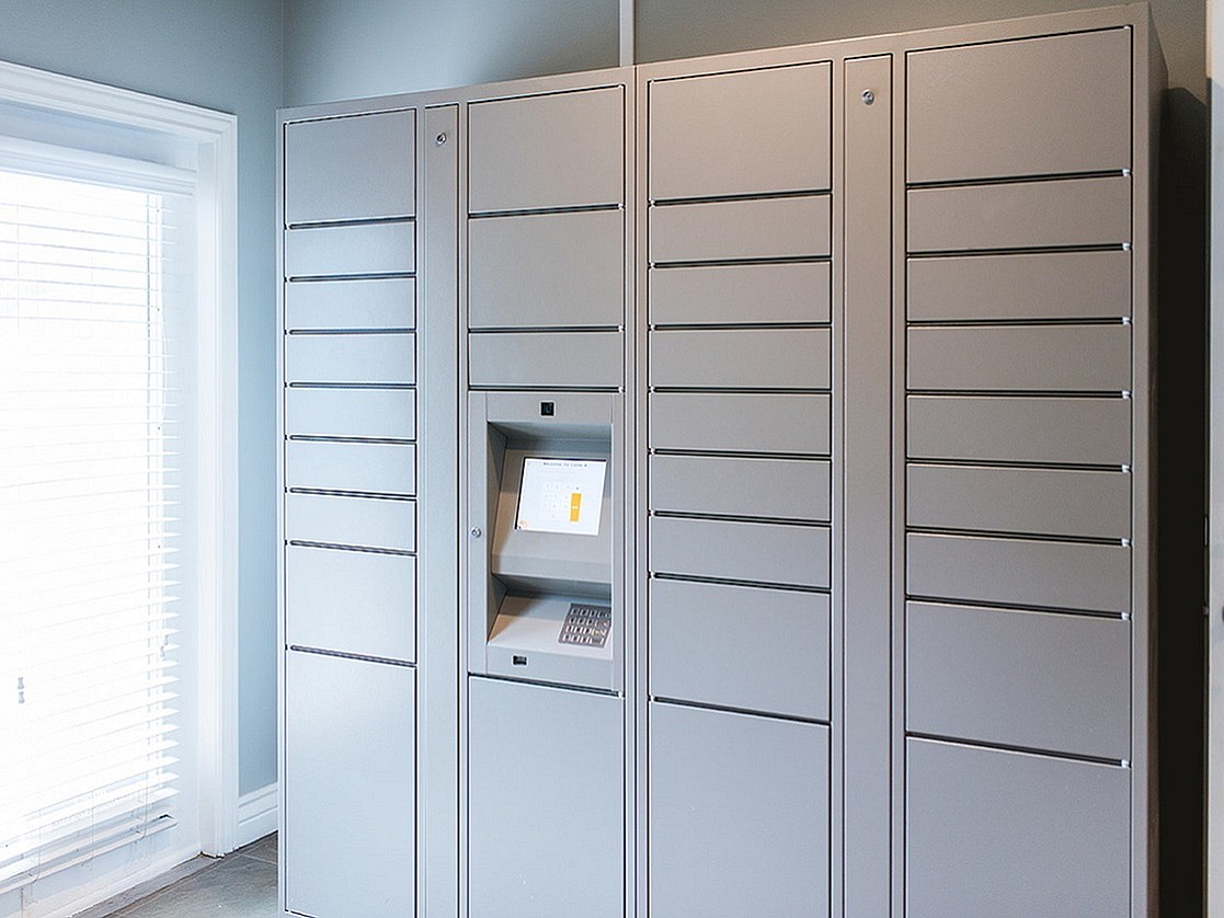 Modern mail organizer with secure lockers and digital interface, perfect for streamlined package management.