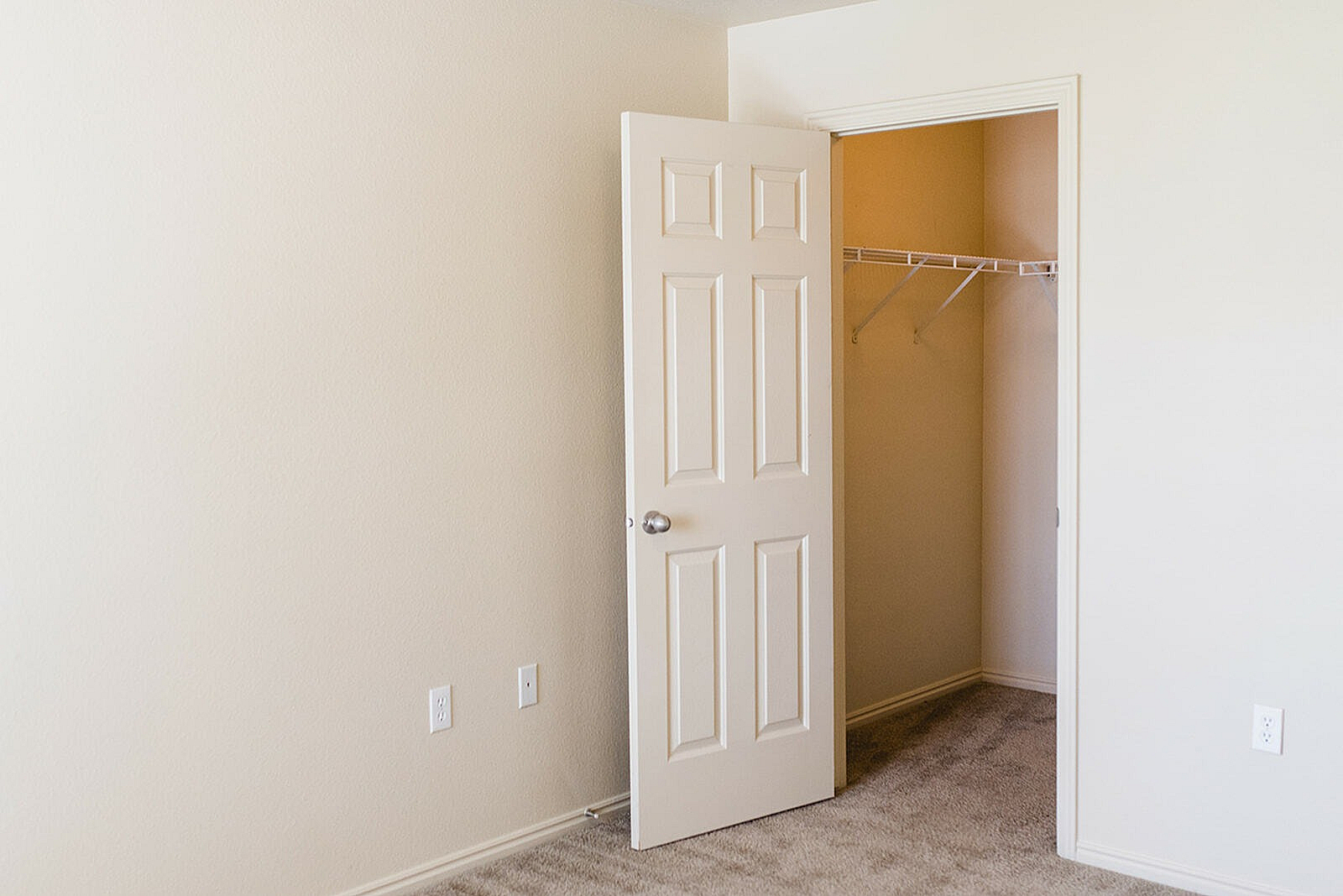Bright and inviting room featuring an open closet with ample storage space, perfect for organizing your wardrobe.
